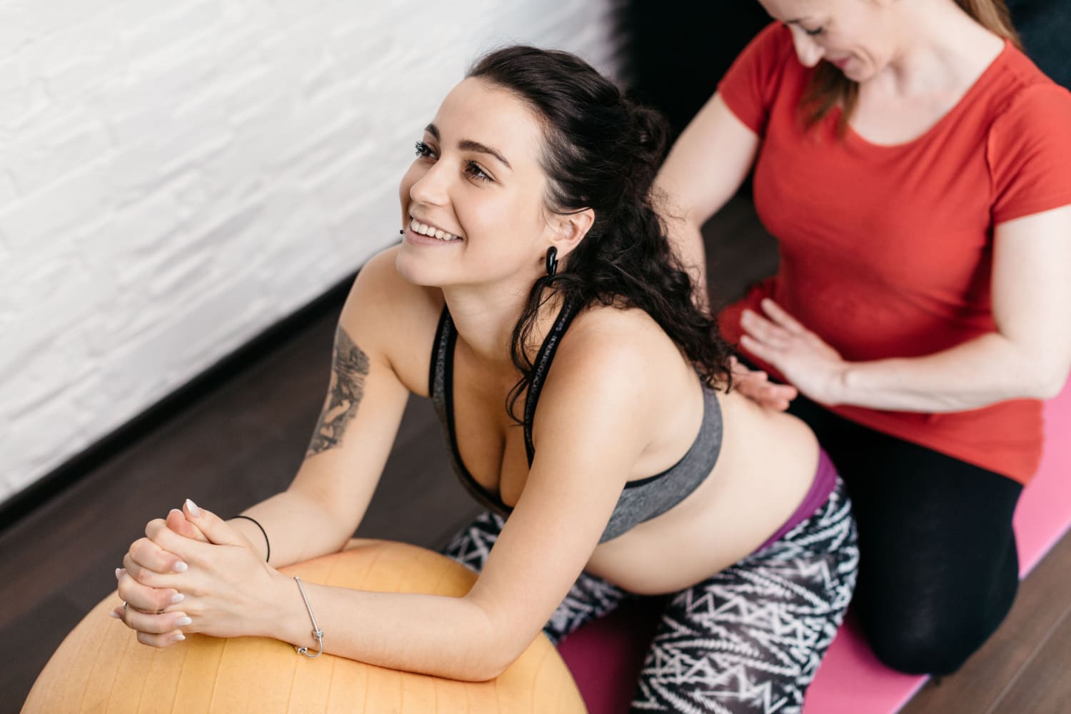 happy pregnant woman getting prenatal massage
