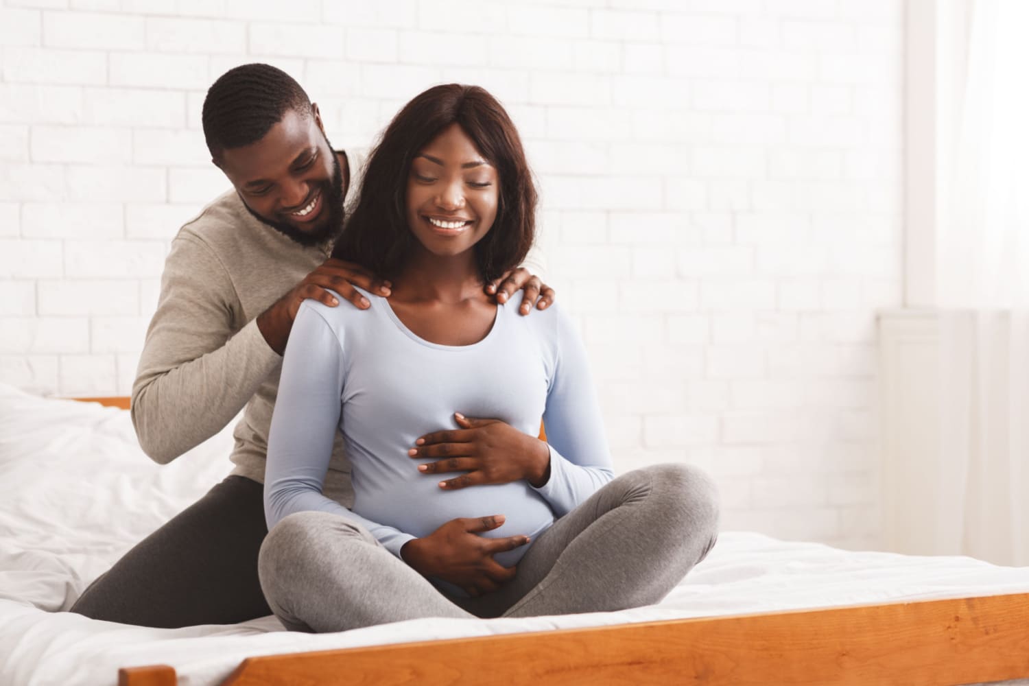 husband massaging his pregnant wife