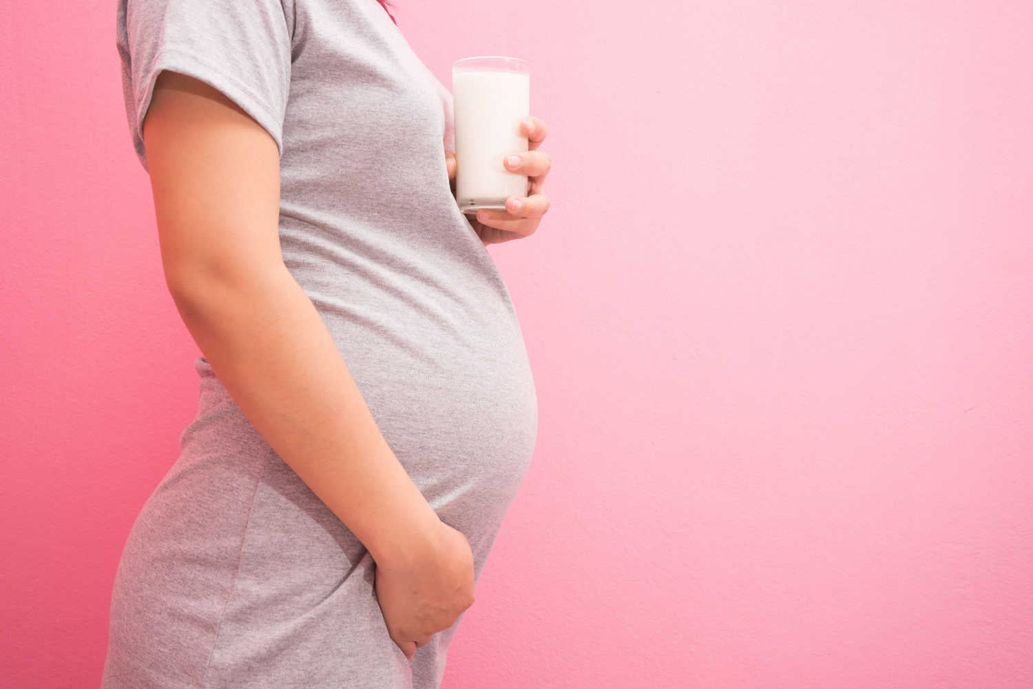 Pregnant woman holding a nutritional drink glass