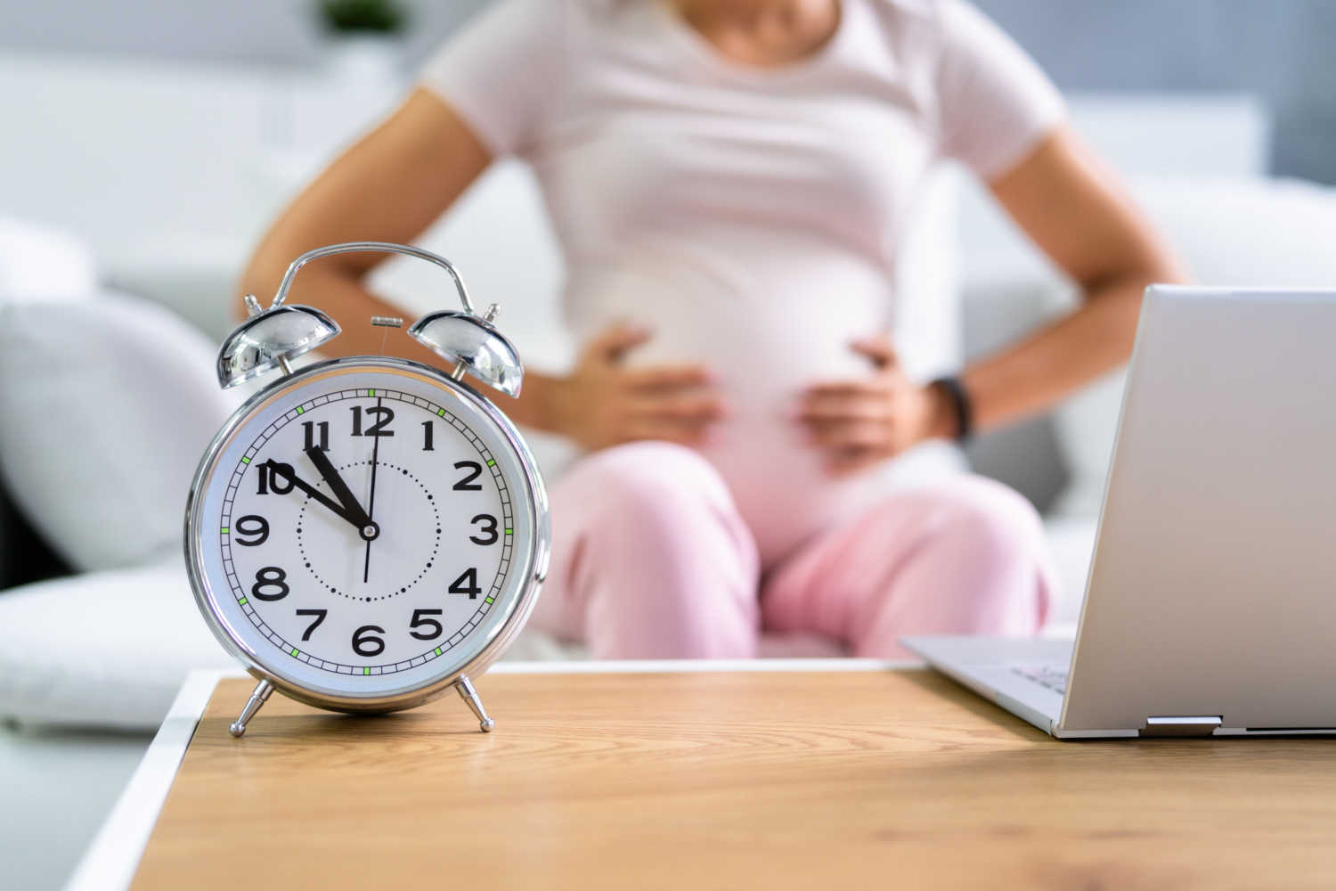 pregnant woman holding her belly