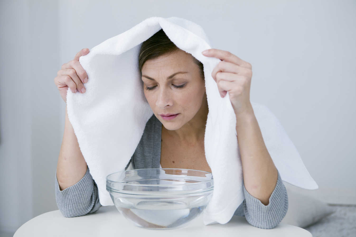 woman taking steam inhalation