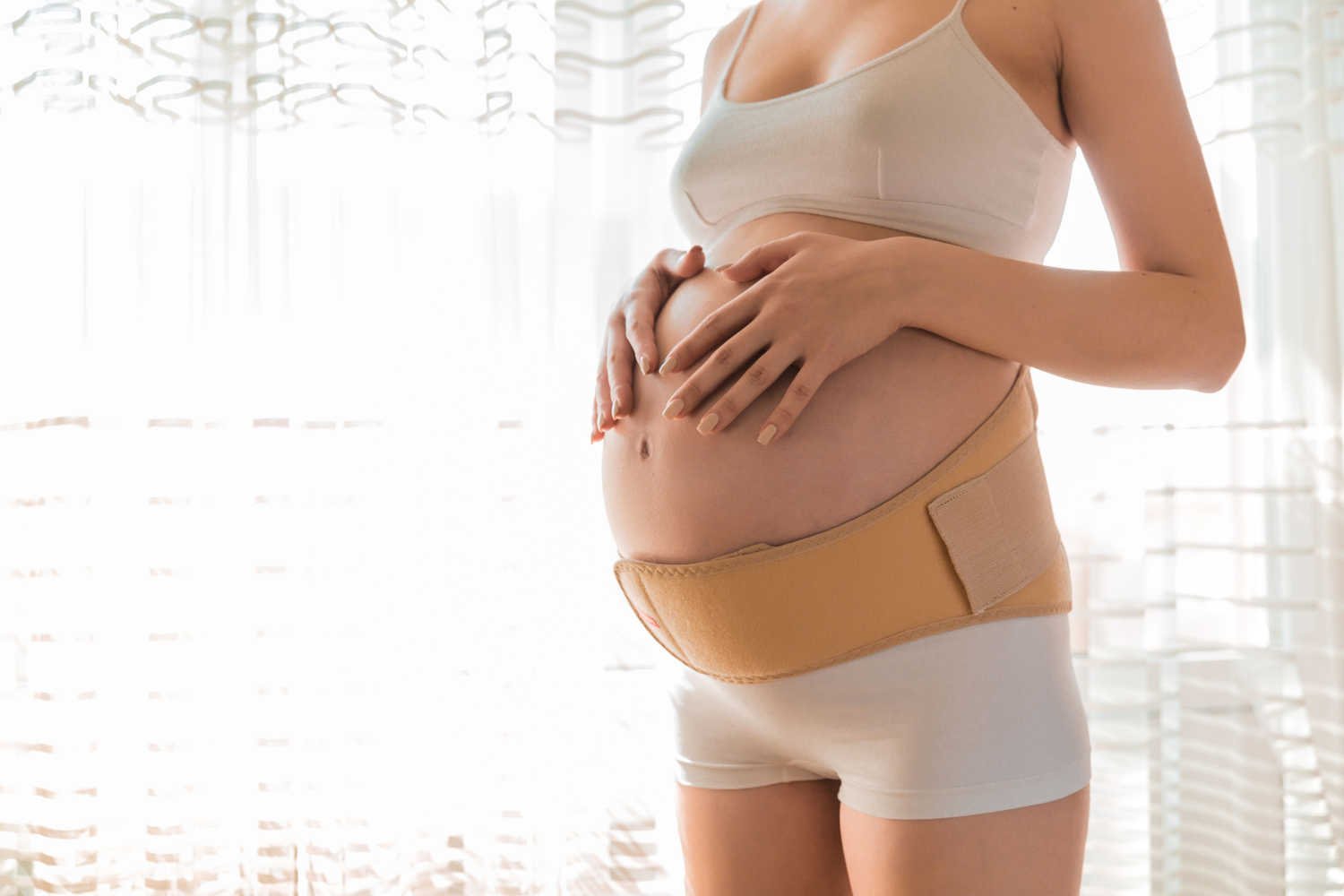 woman wearing a belly band-a third trimester essential
