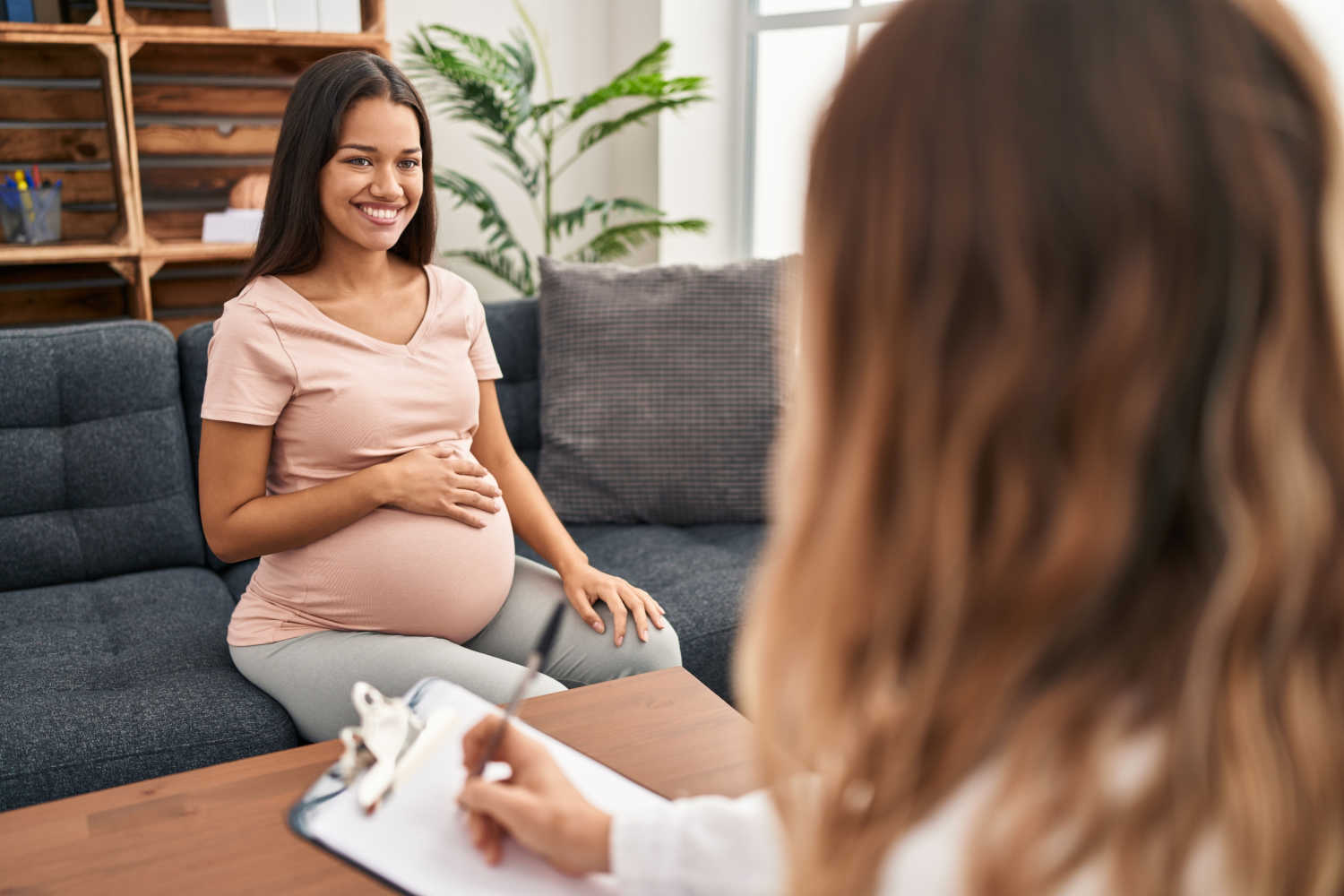 pregnant woman talking with therapist
