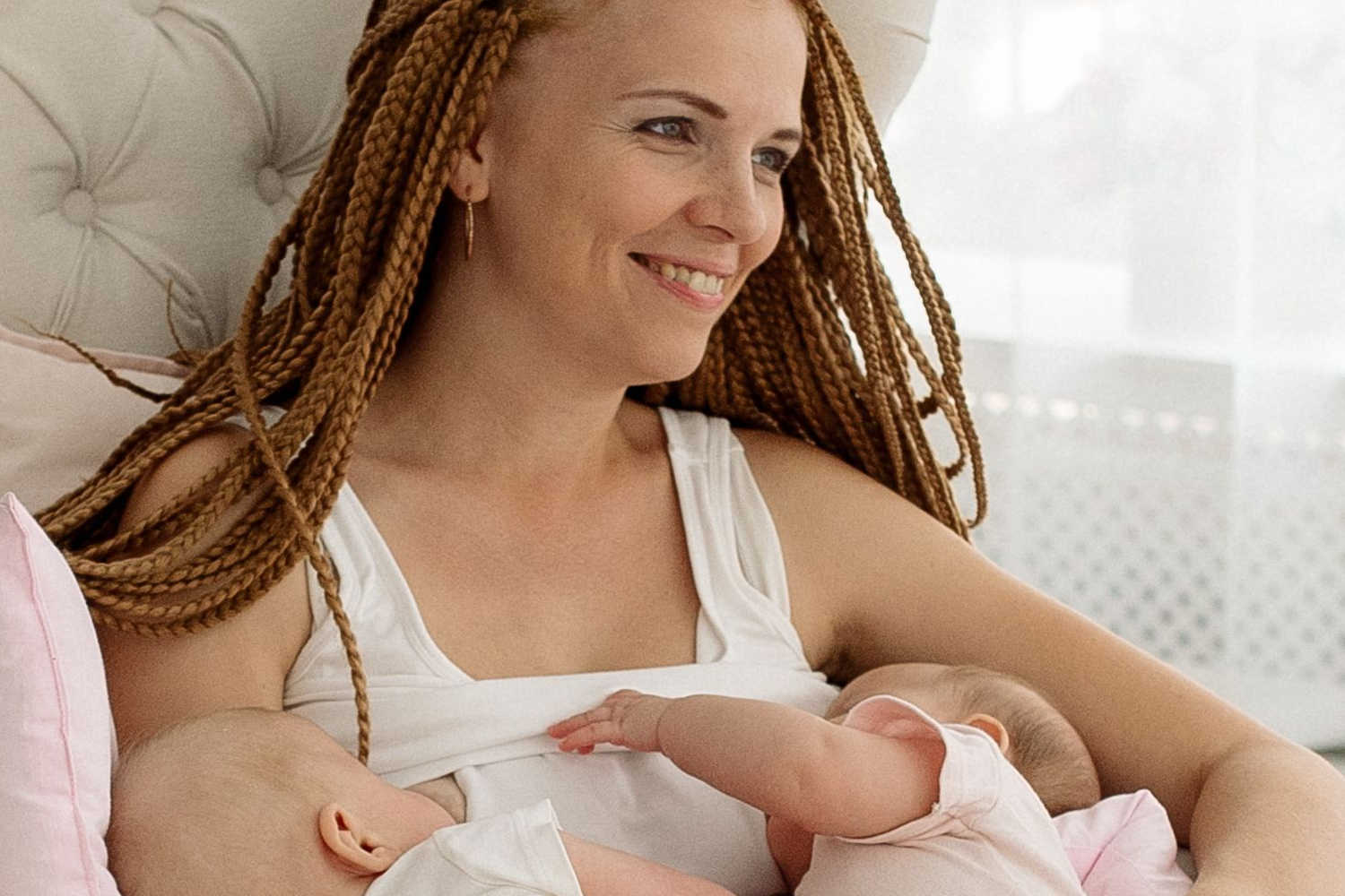 woman breastfeeding twins