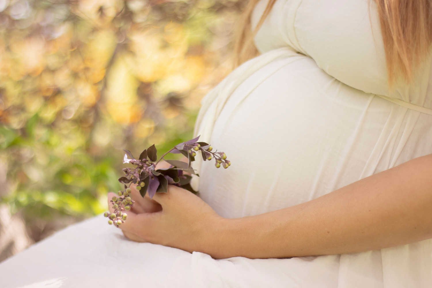 pregnant woman with a flower in hand