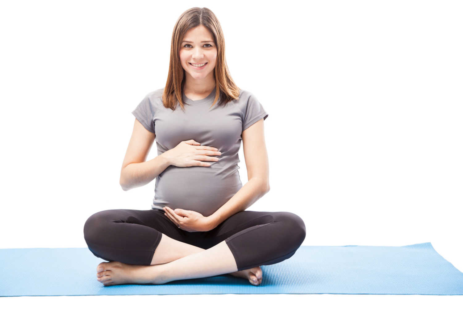 pregnant woman sitting on a yoga mat