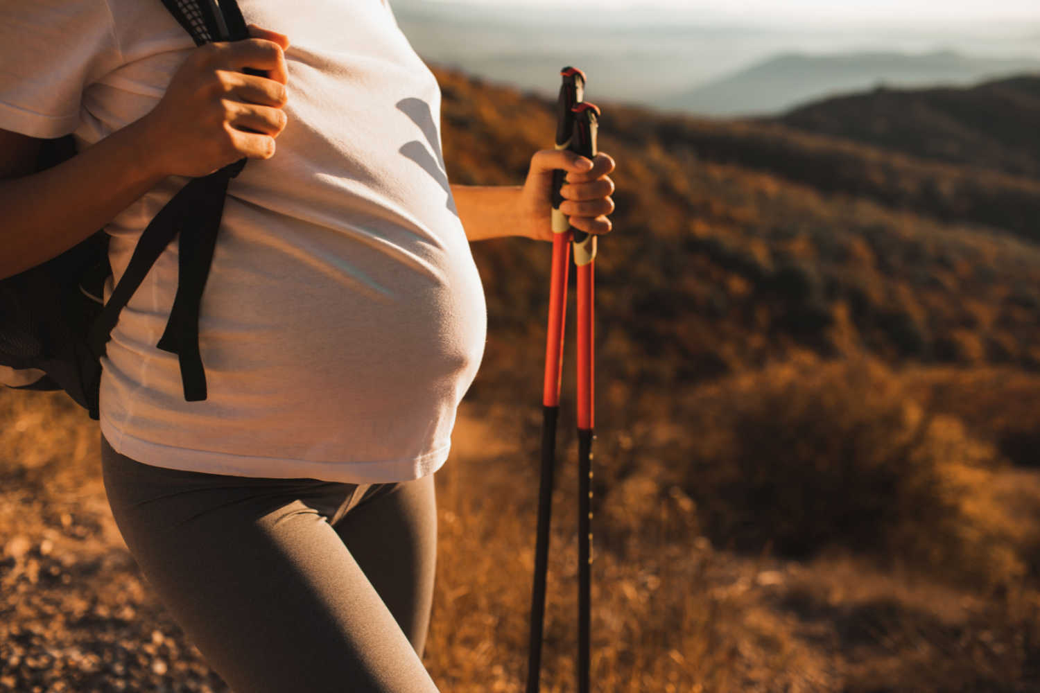 pregnant woman with hiking sticks