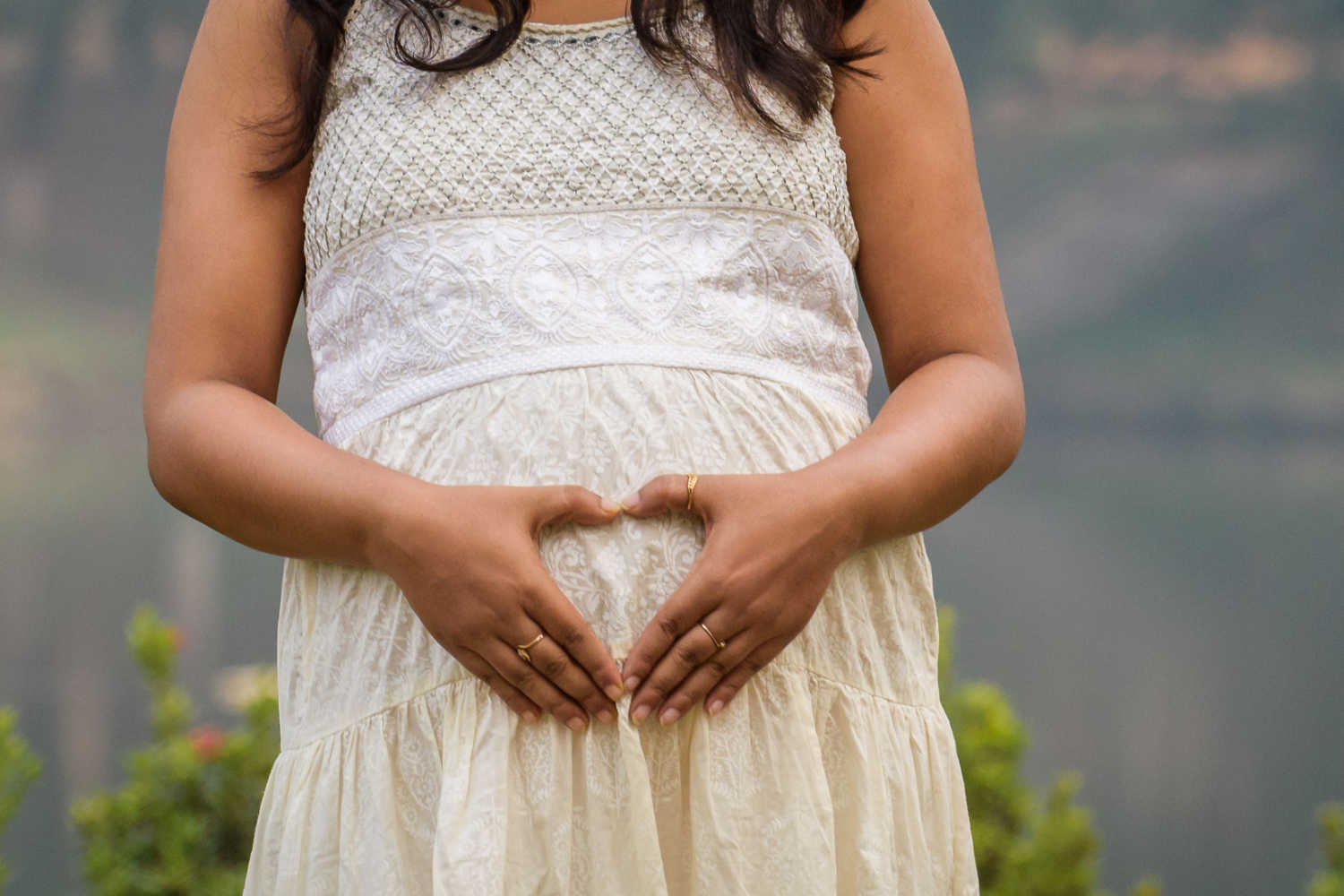 pregnant woman holding her belly