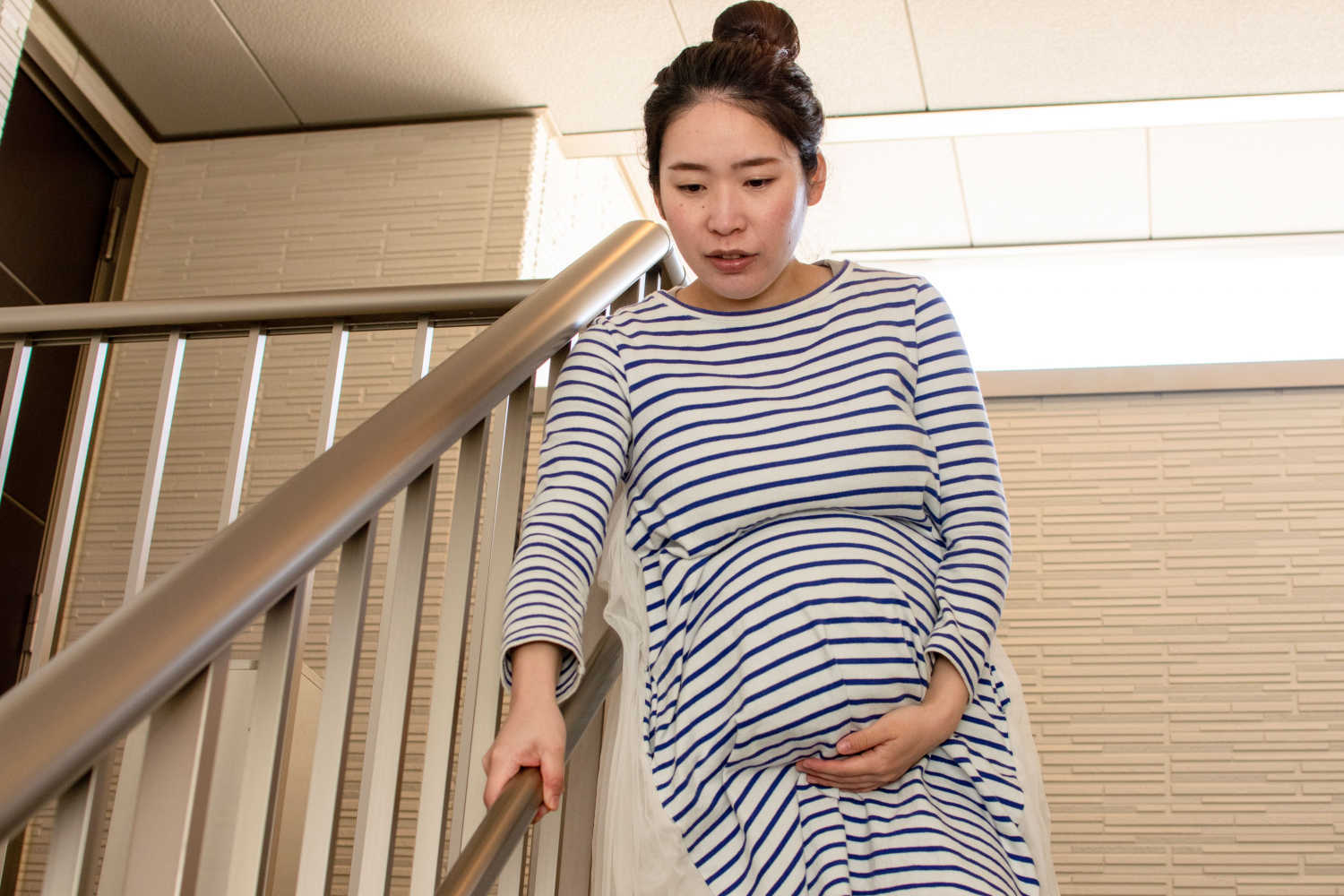 woman being cautious to overcome clumsiness during pregnancy