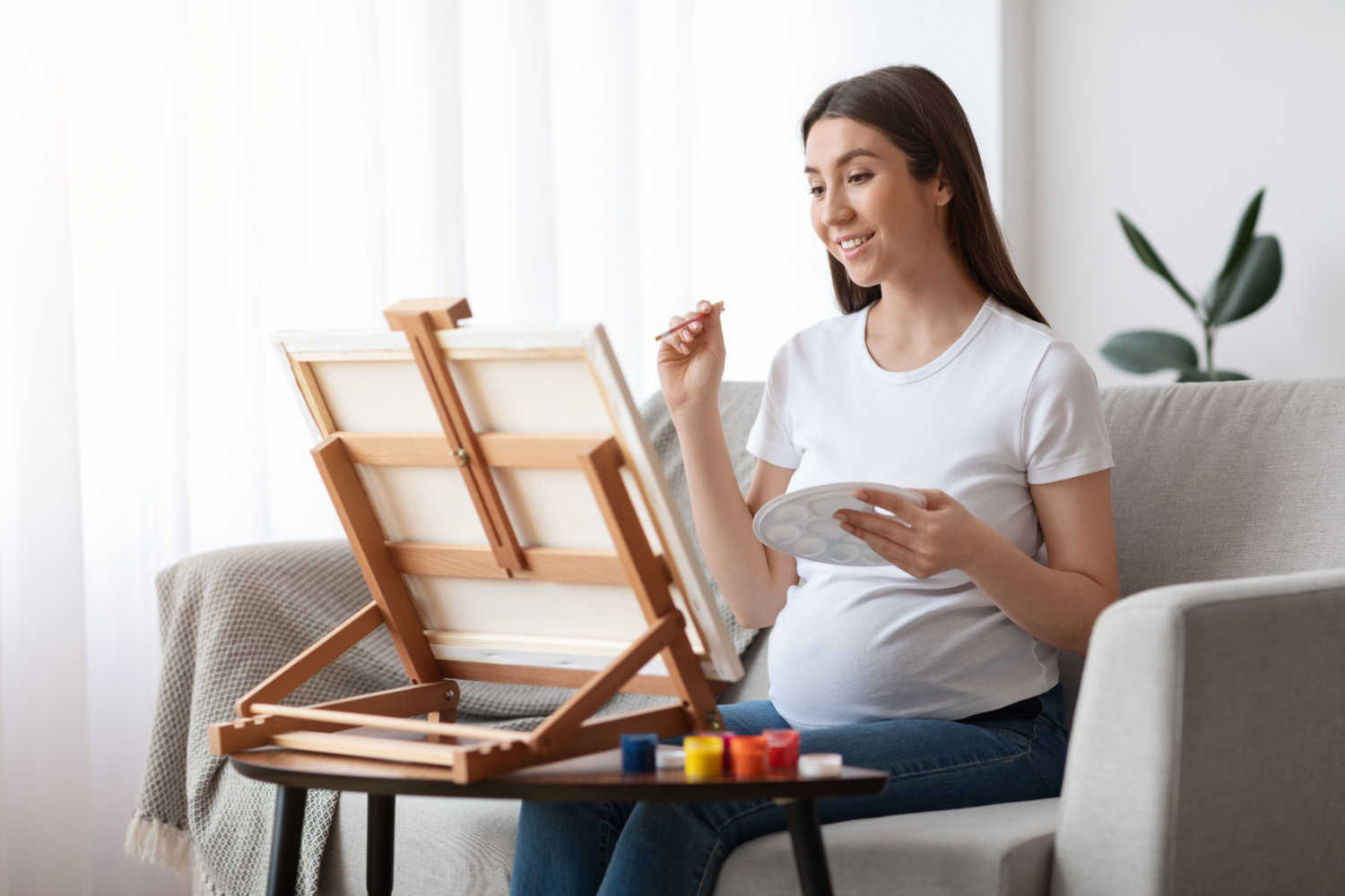 pregnant woman working on painting