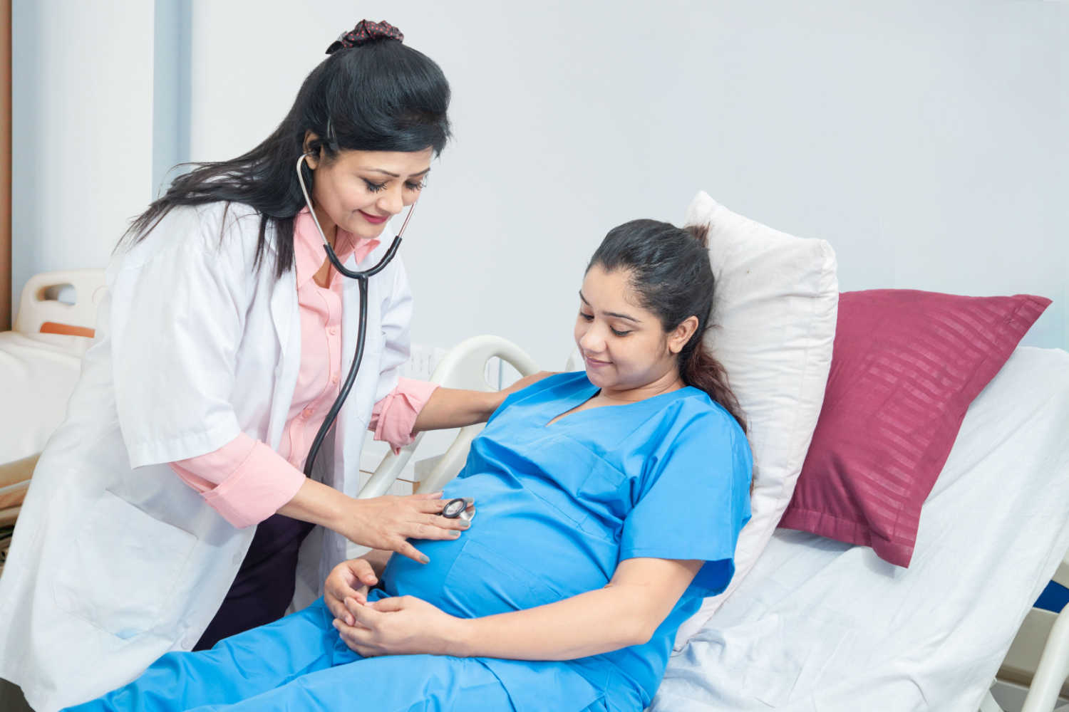 pregnant woman getting checked by a doctor