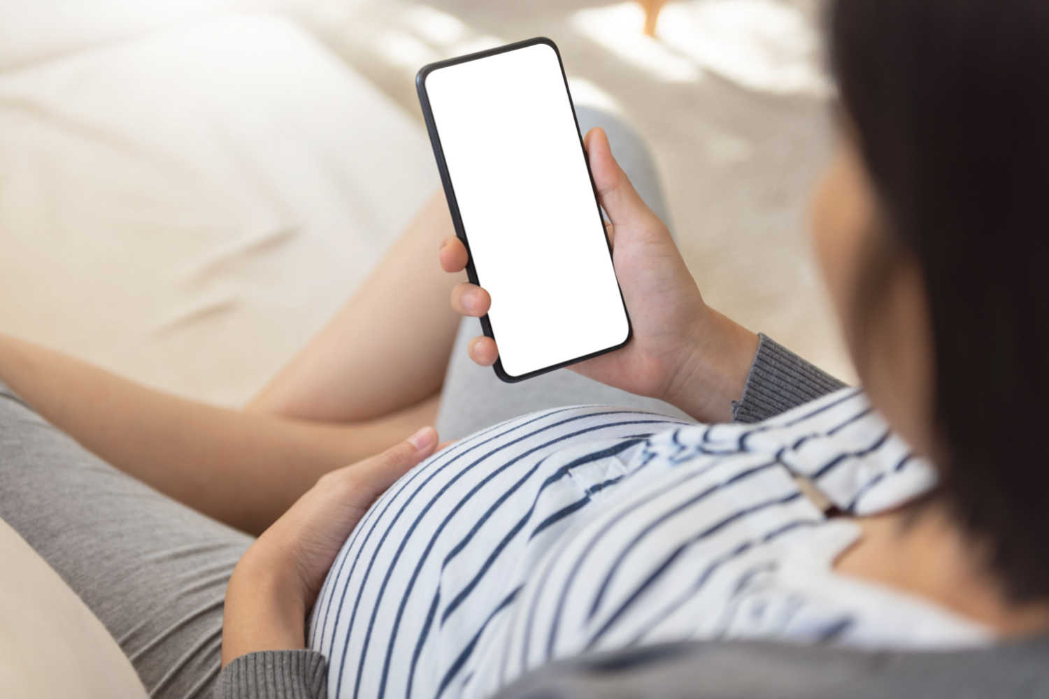 pregnant woman with mobile phone in hand