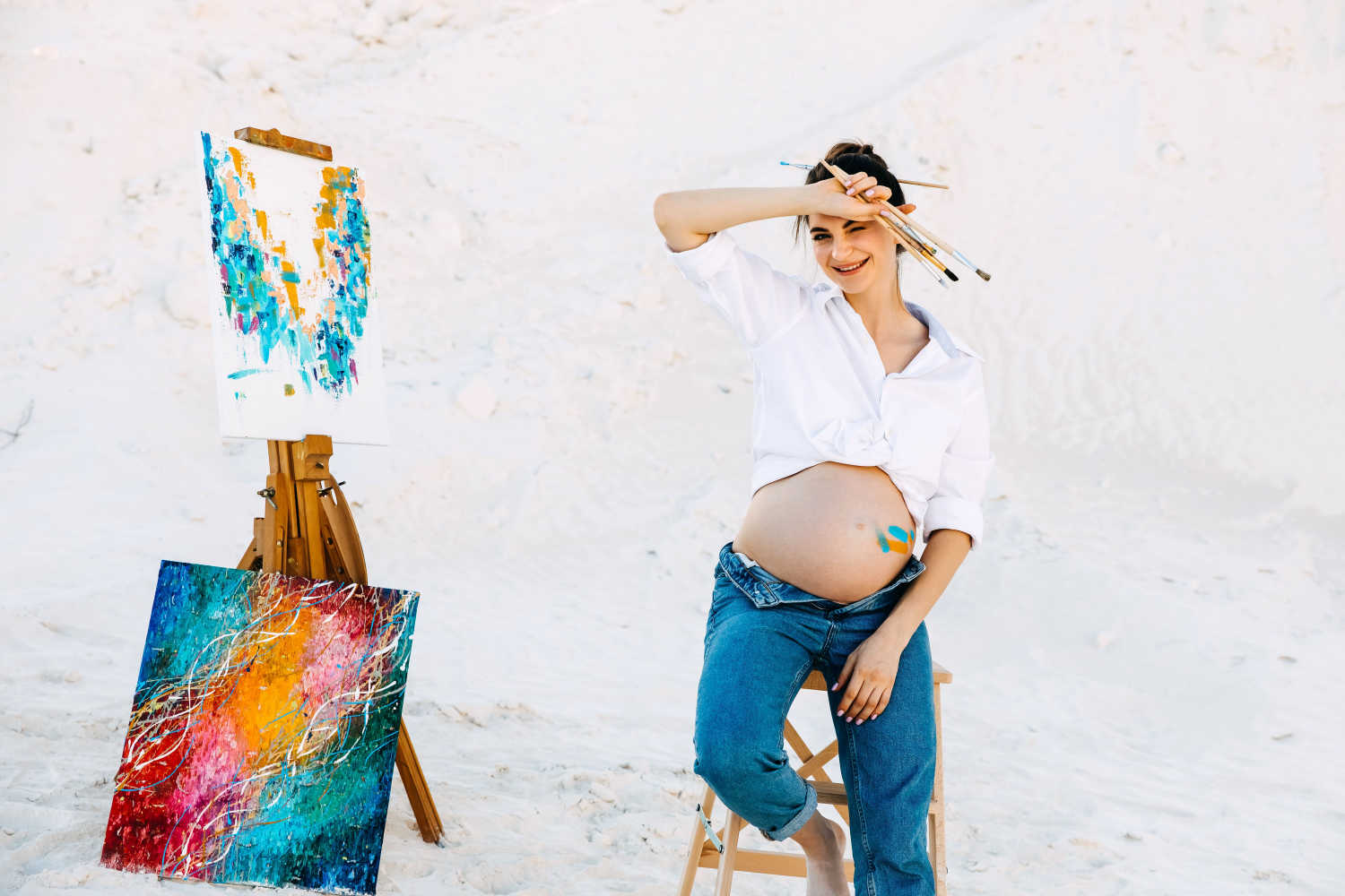 pregnant woman painting outdoors