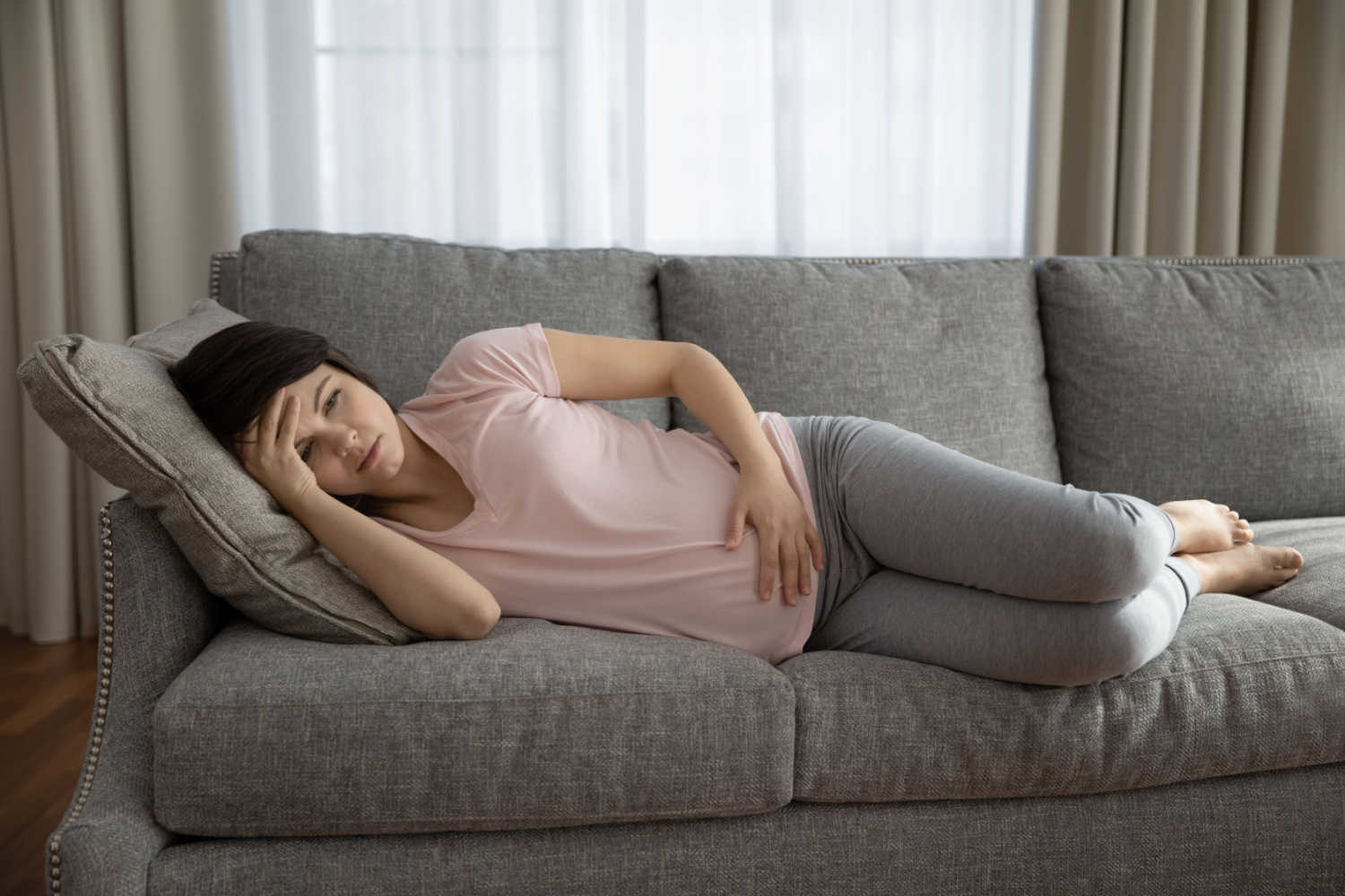 pregnant woman lying on sofa