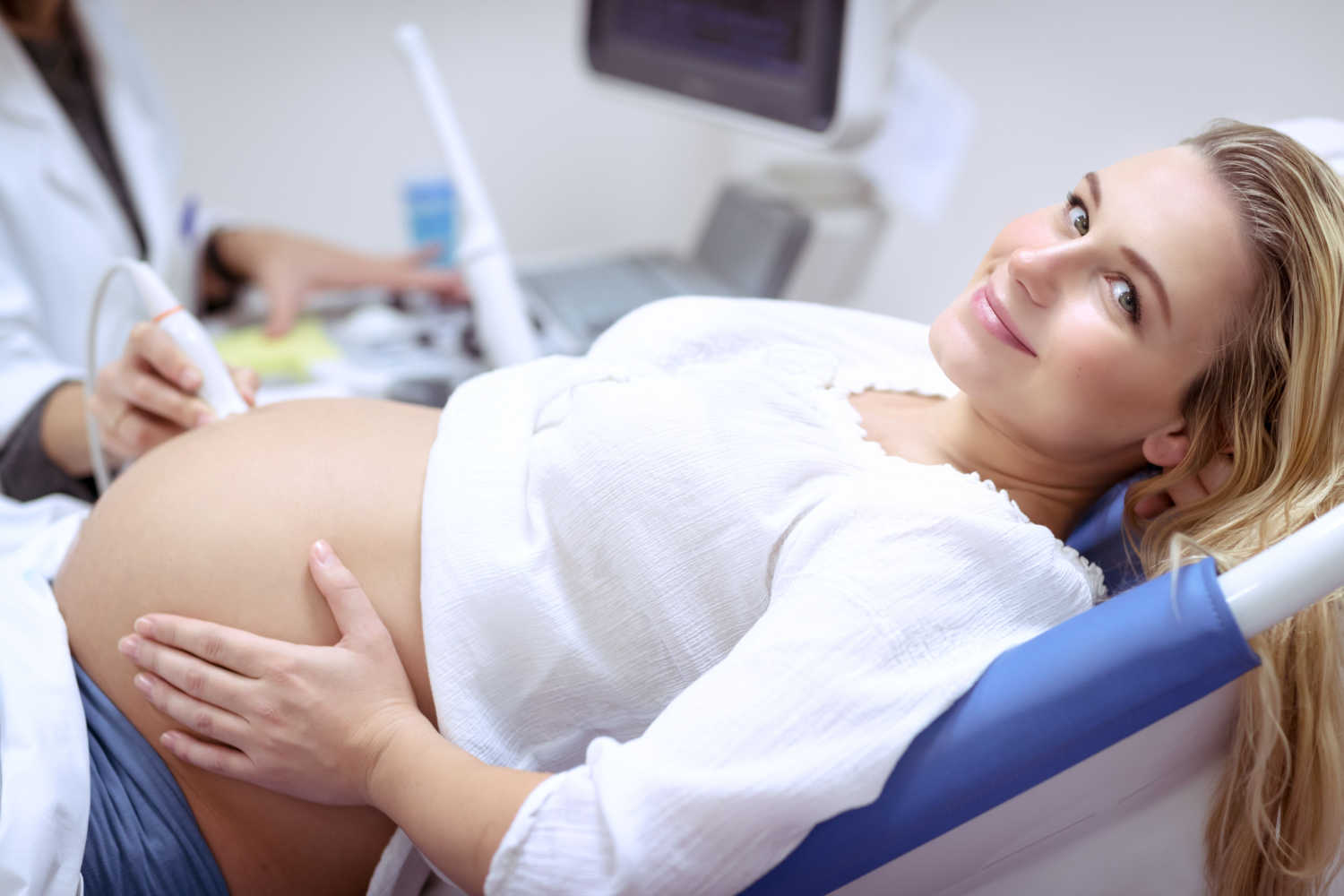 pregnant woman getting checked by doctor