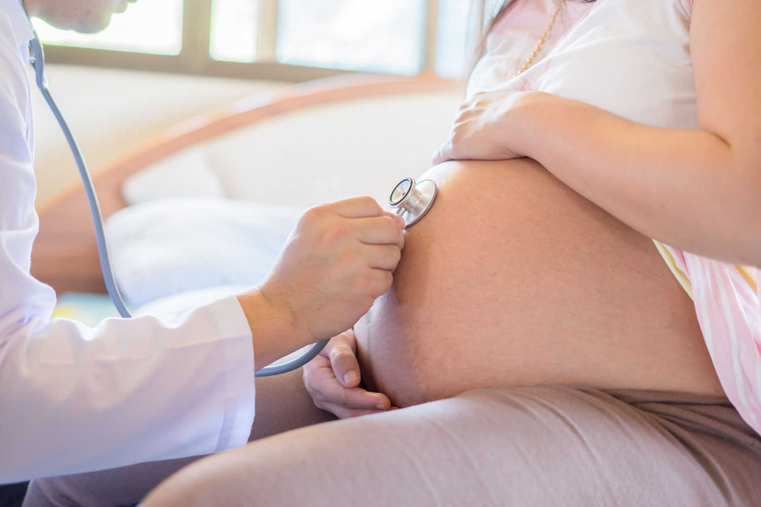 Doctor checking pregnant woman during prenatal visits schedule
