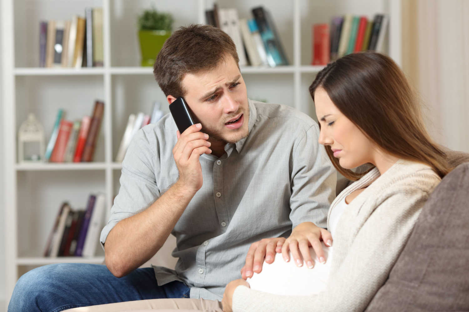 pregnant couple calling doctor
