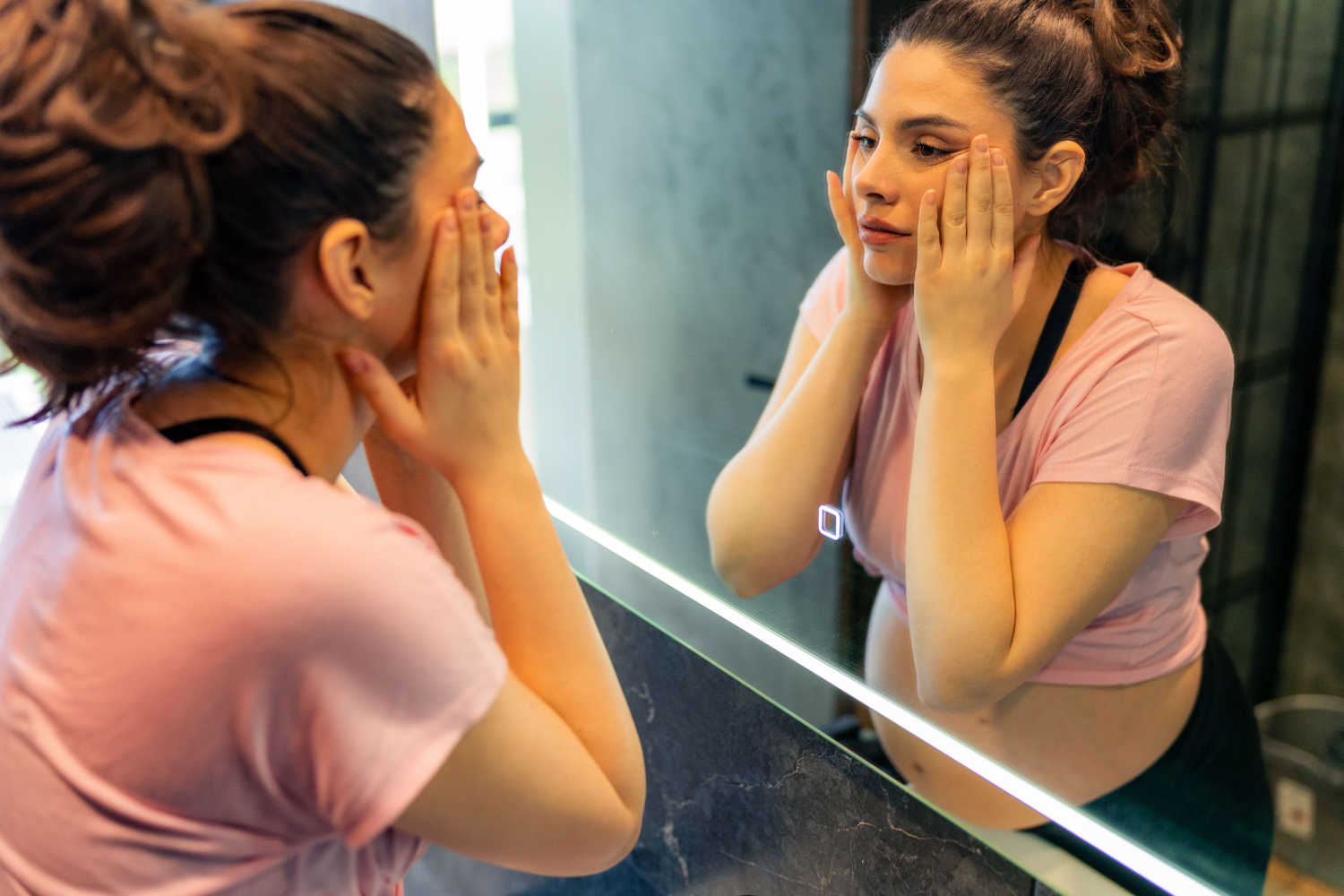 woman looking at mirror