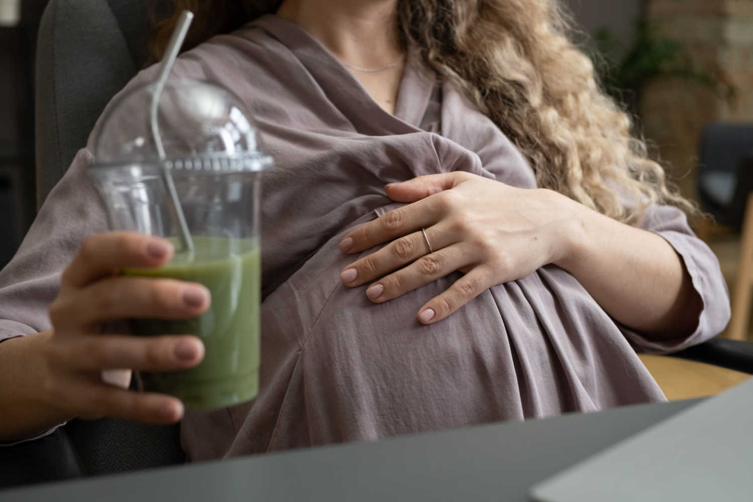 pregnant woman with a glass of juice