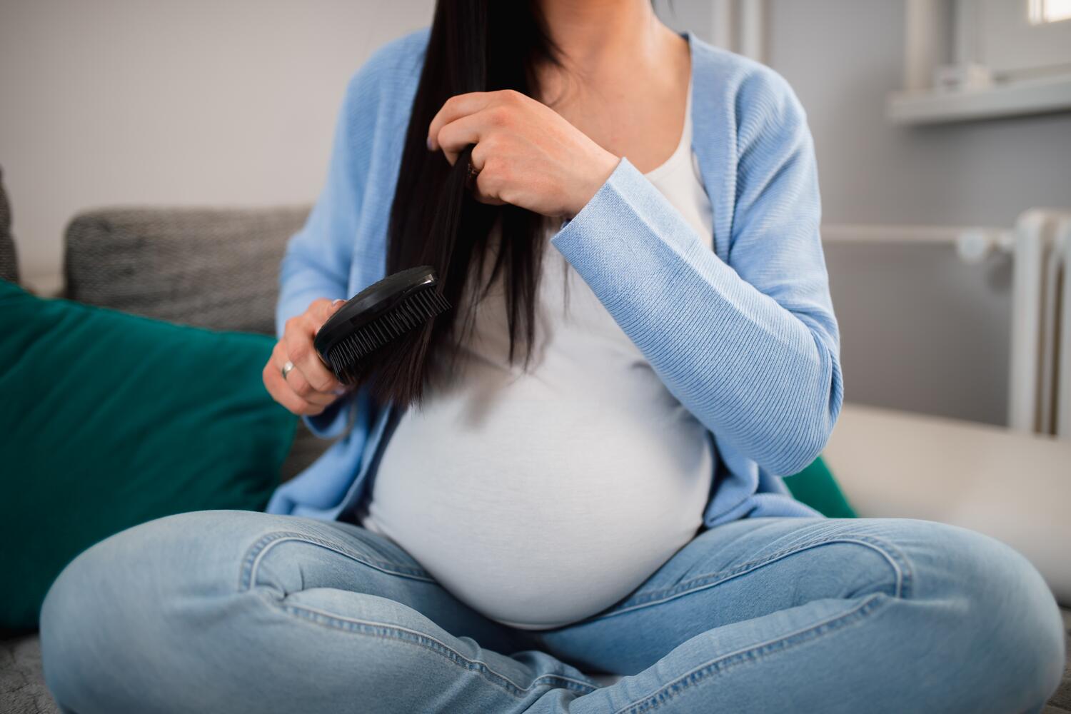 pregnant woman combing hair