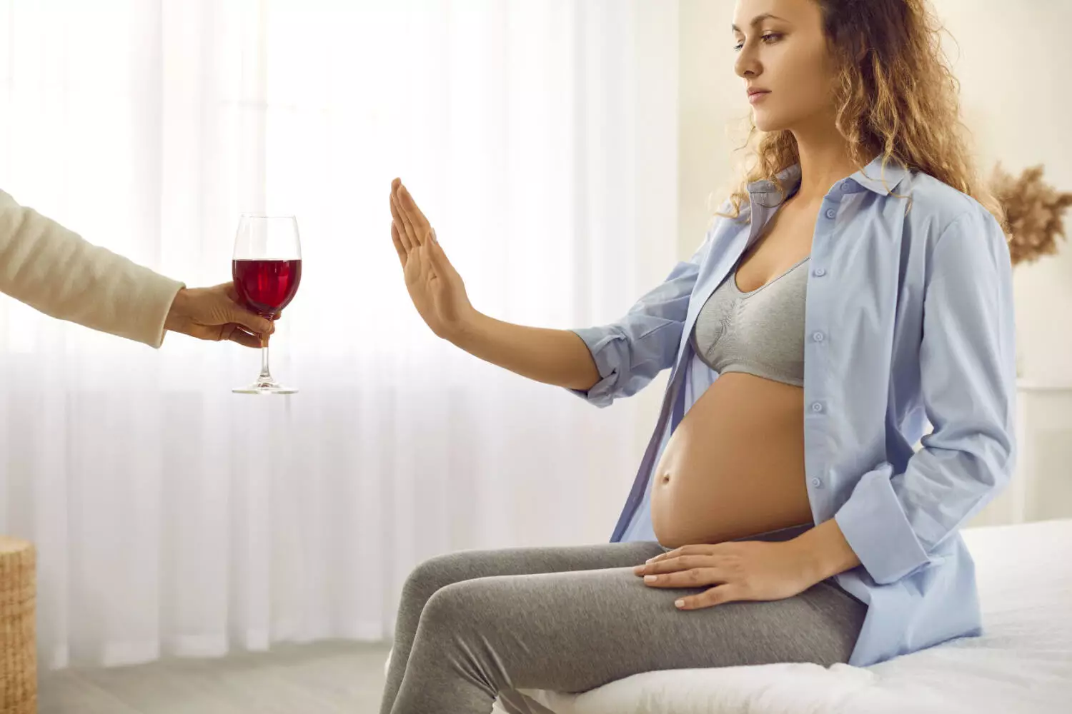 pregnant woman saying no to alcohol
