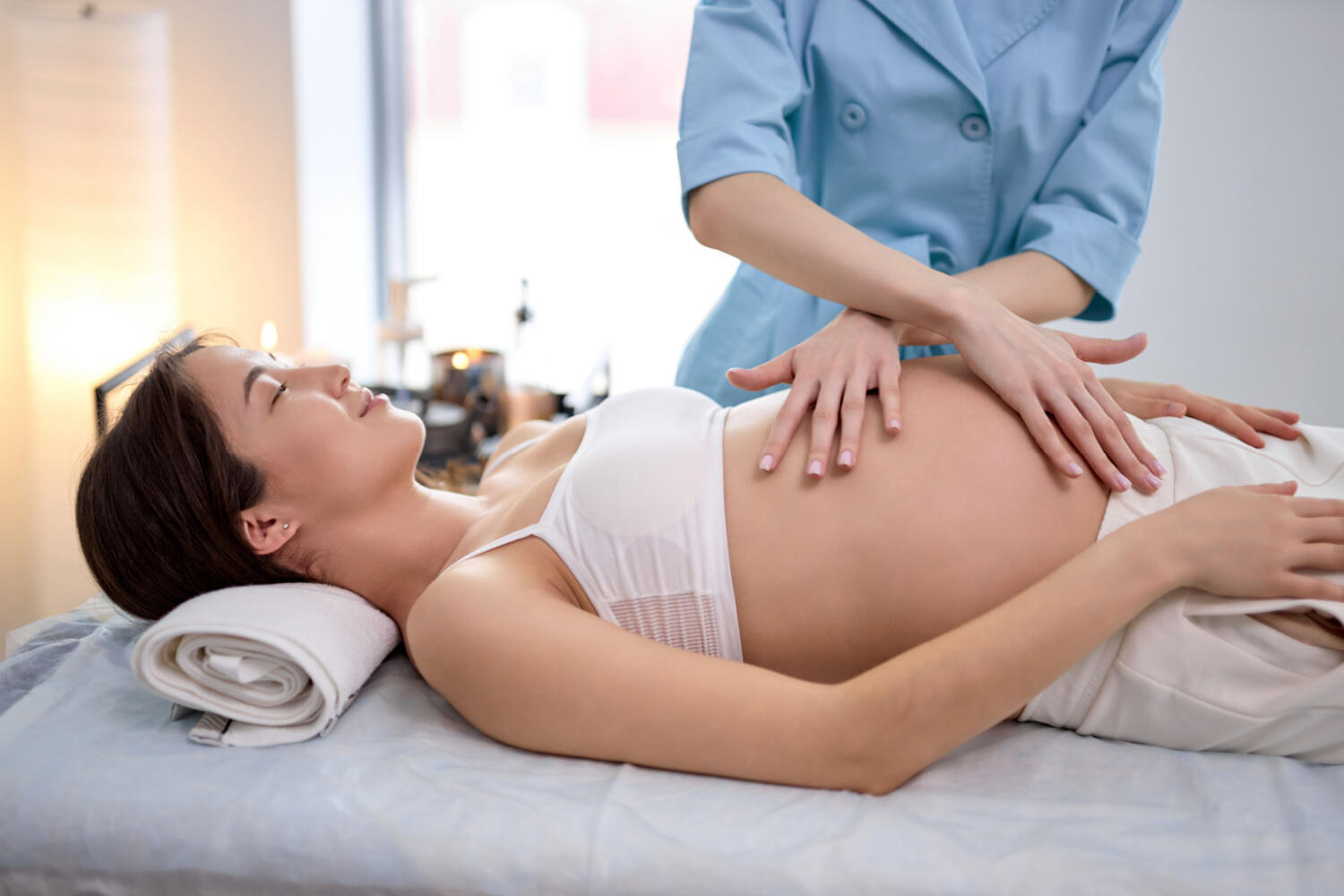 pregnant women receiving tummy massage