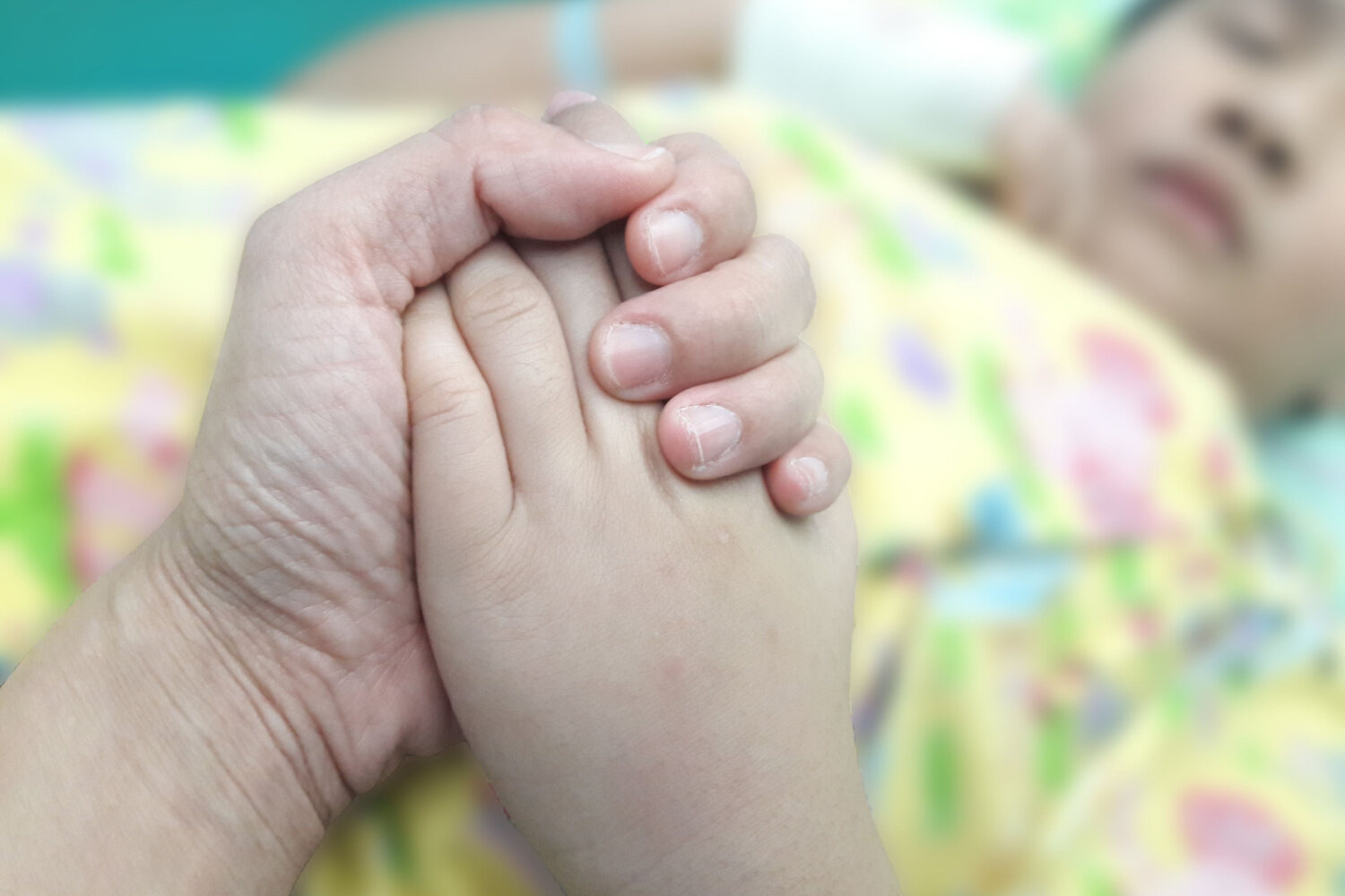 Mother holding a toddler's hand