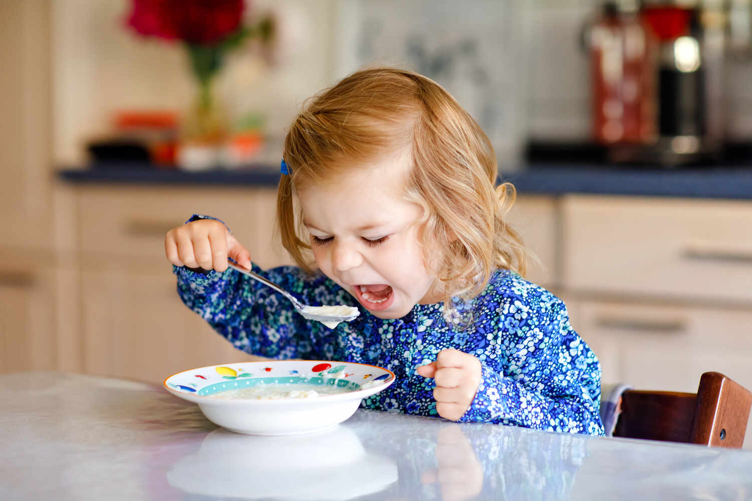 A toddler eating whole grain cereal