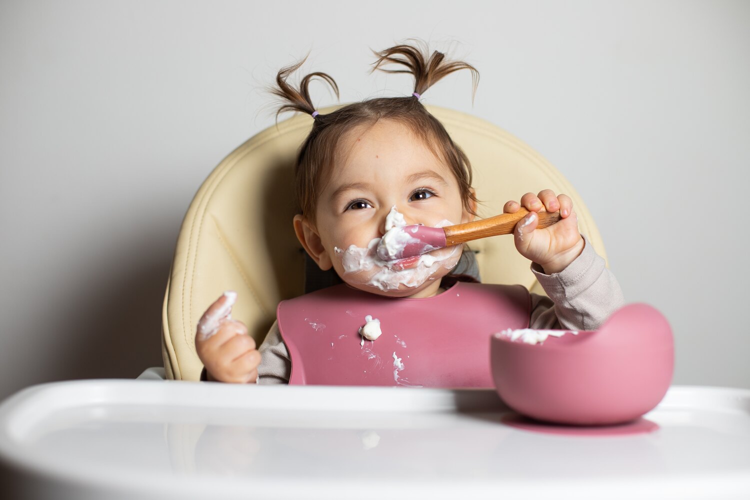 A toddler eating yogurt, a superfood