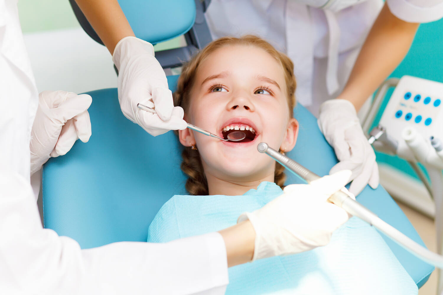 A dentists checking teeth of a child
