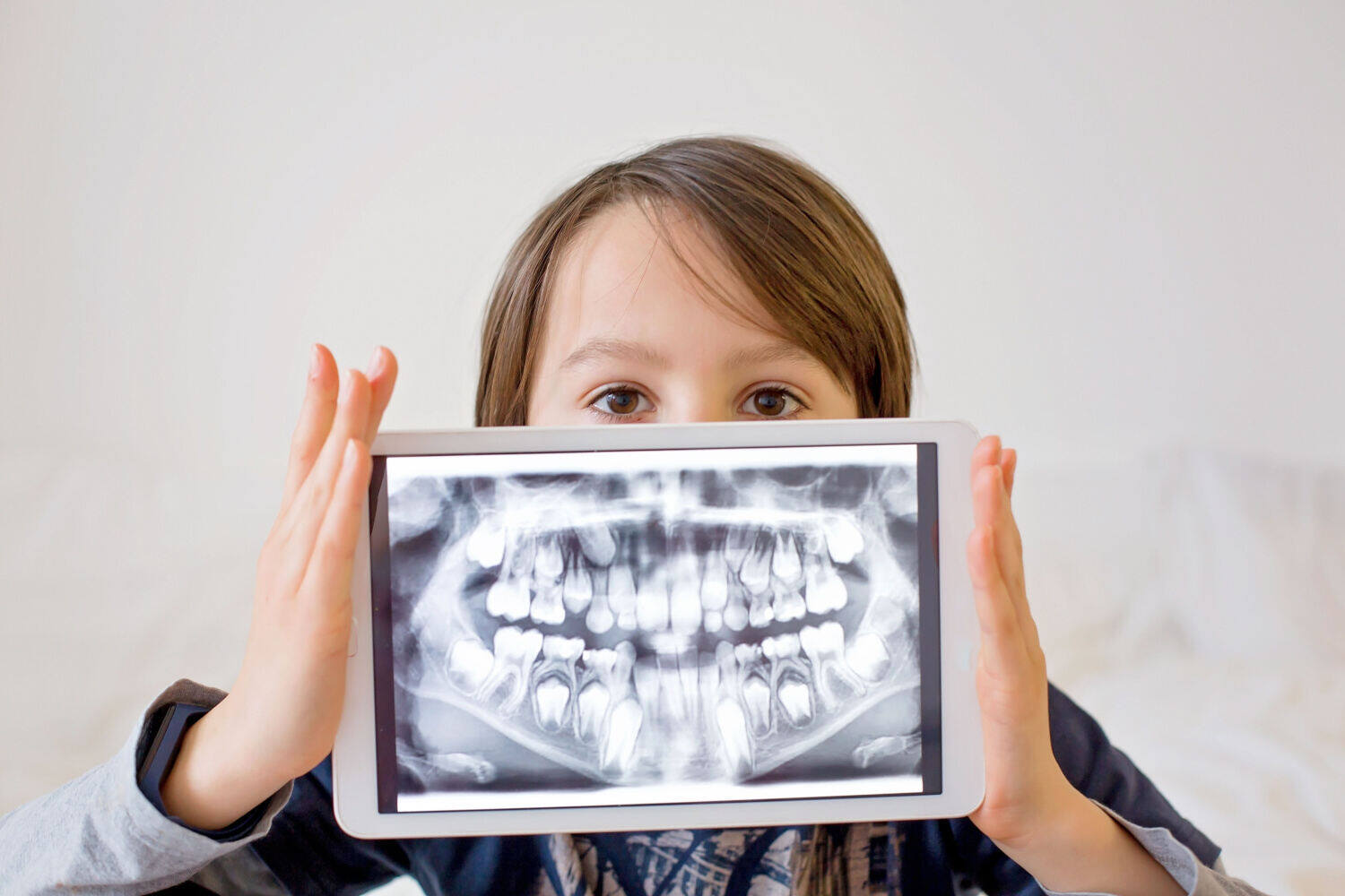 A child holding a dental x-ray