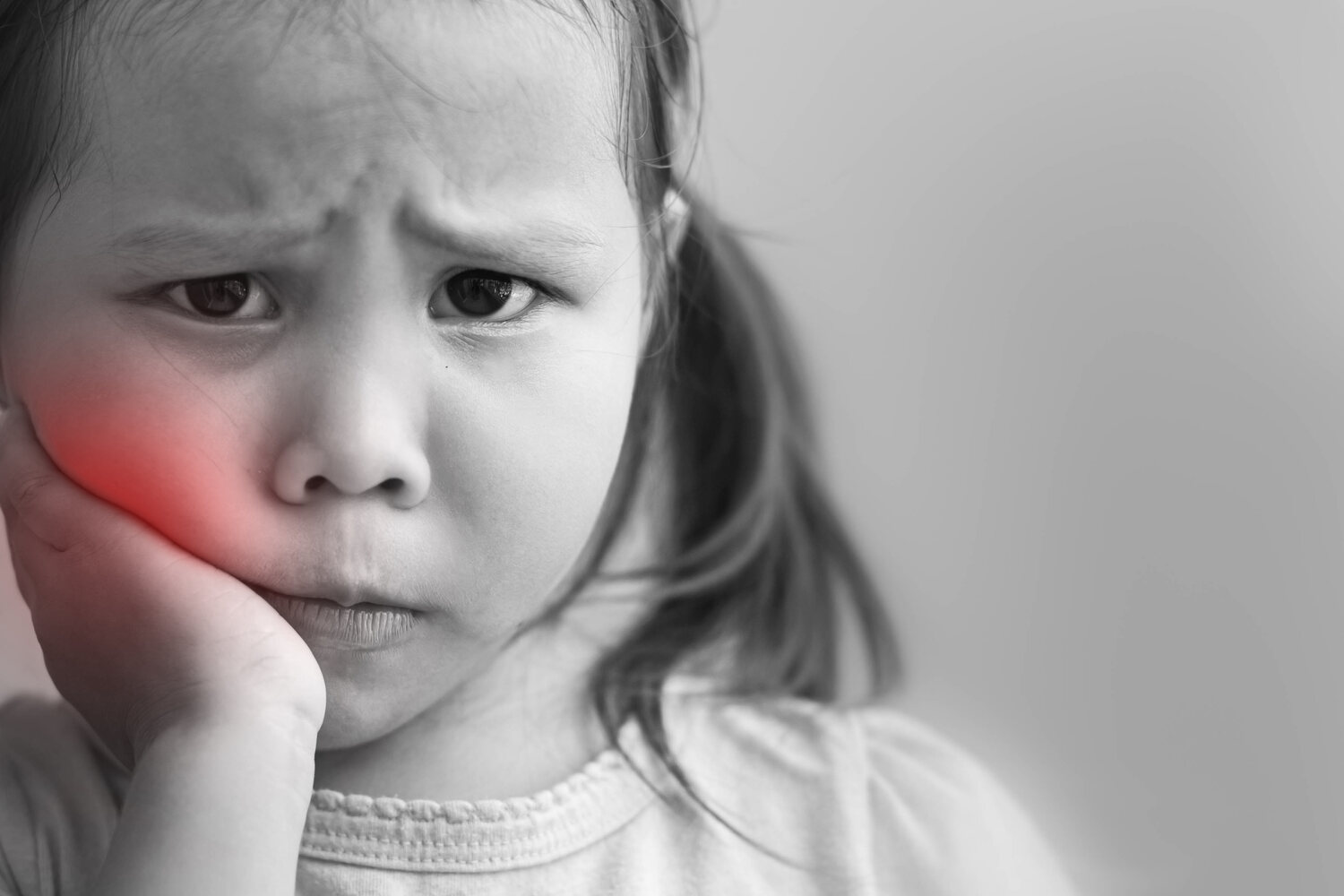 A little girl having tooth ache