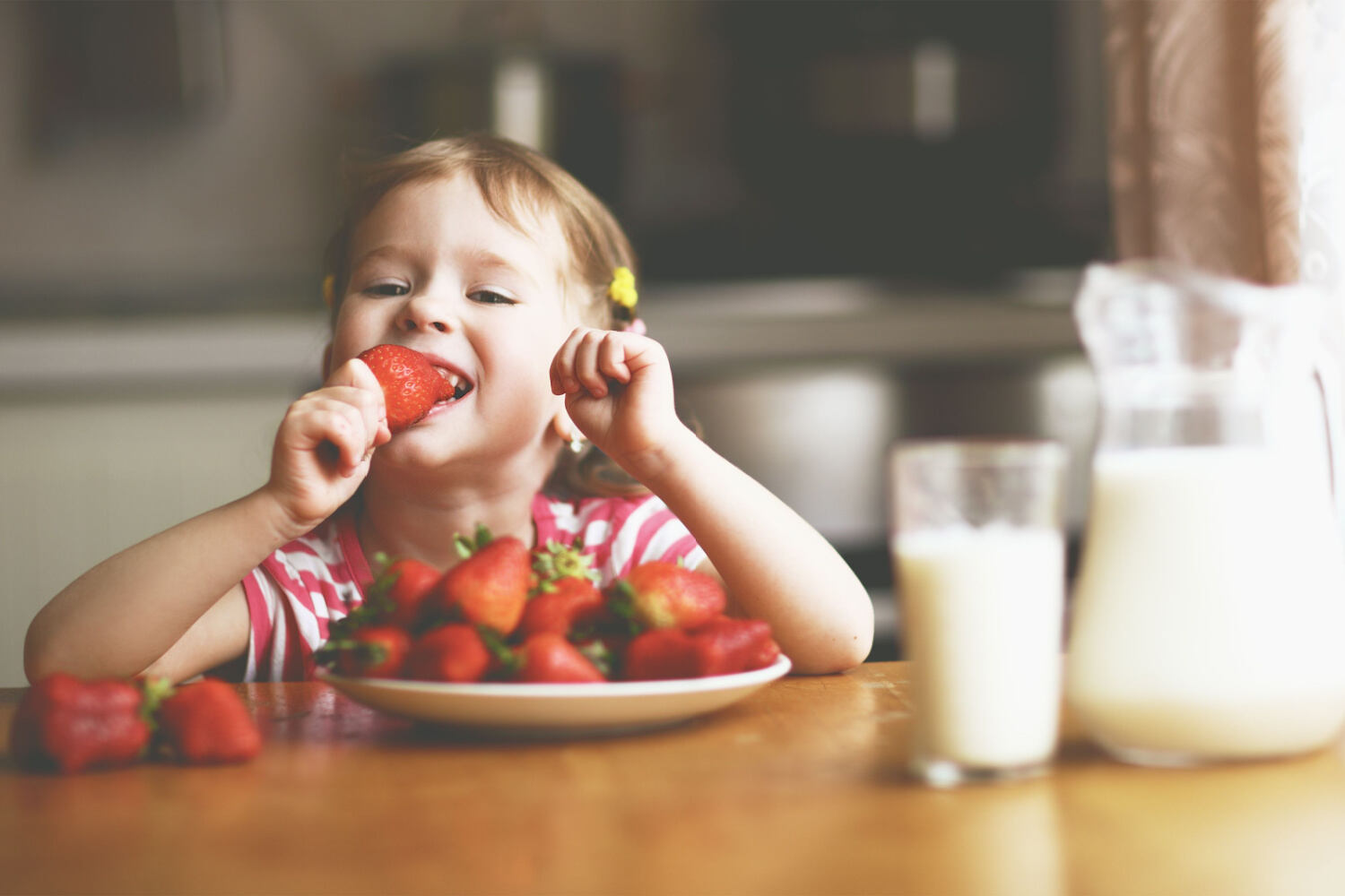 A girl eating strawberries