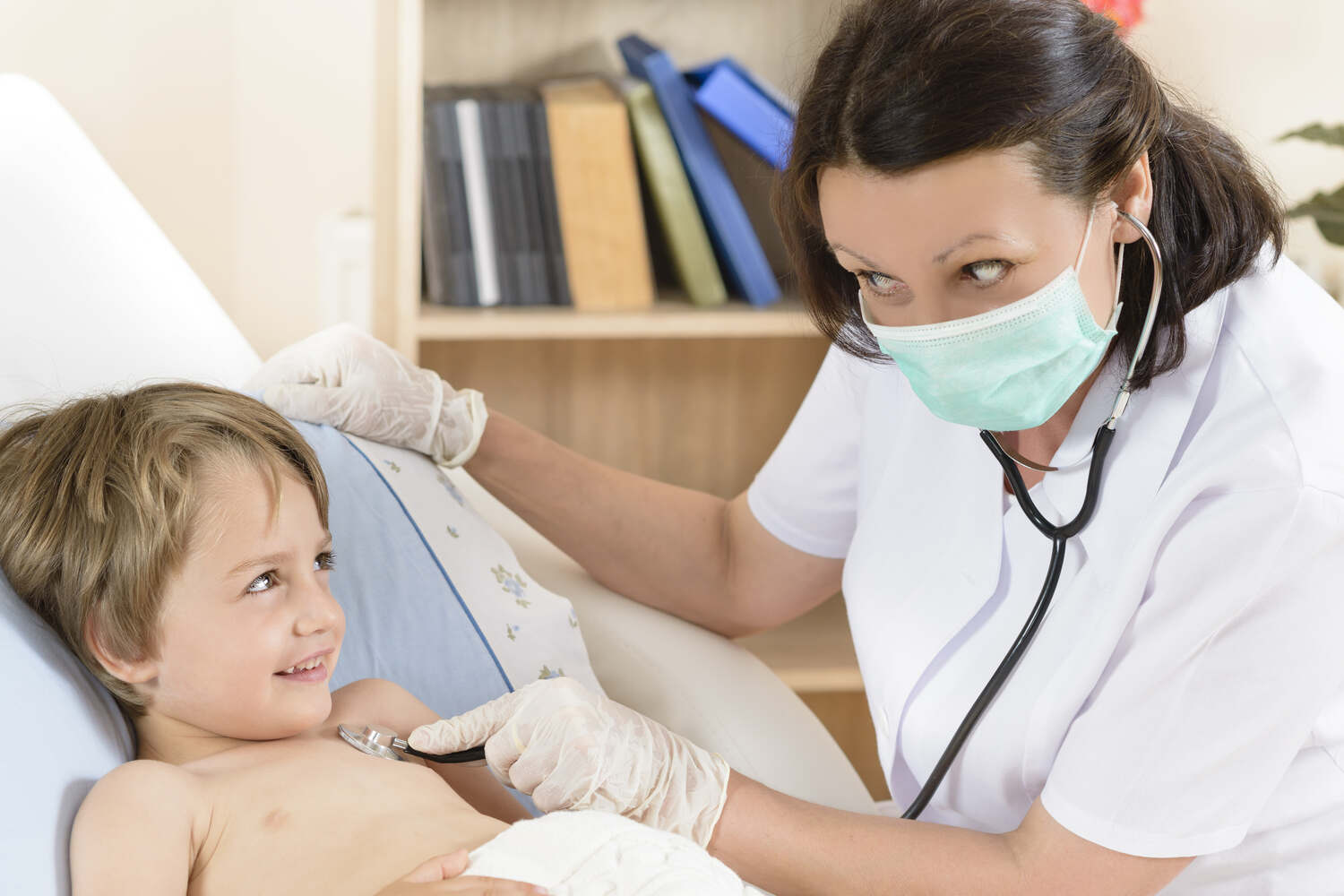 A doctor checking the heartbeat of a child