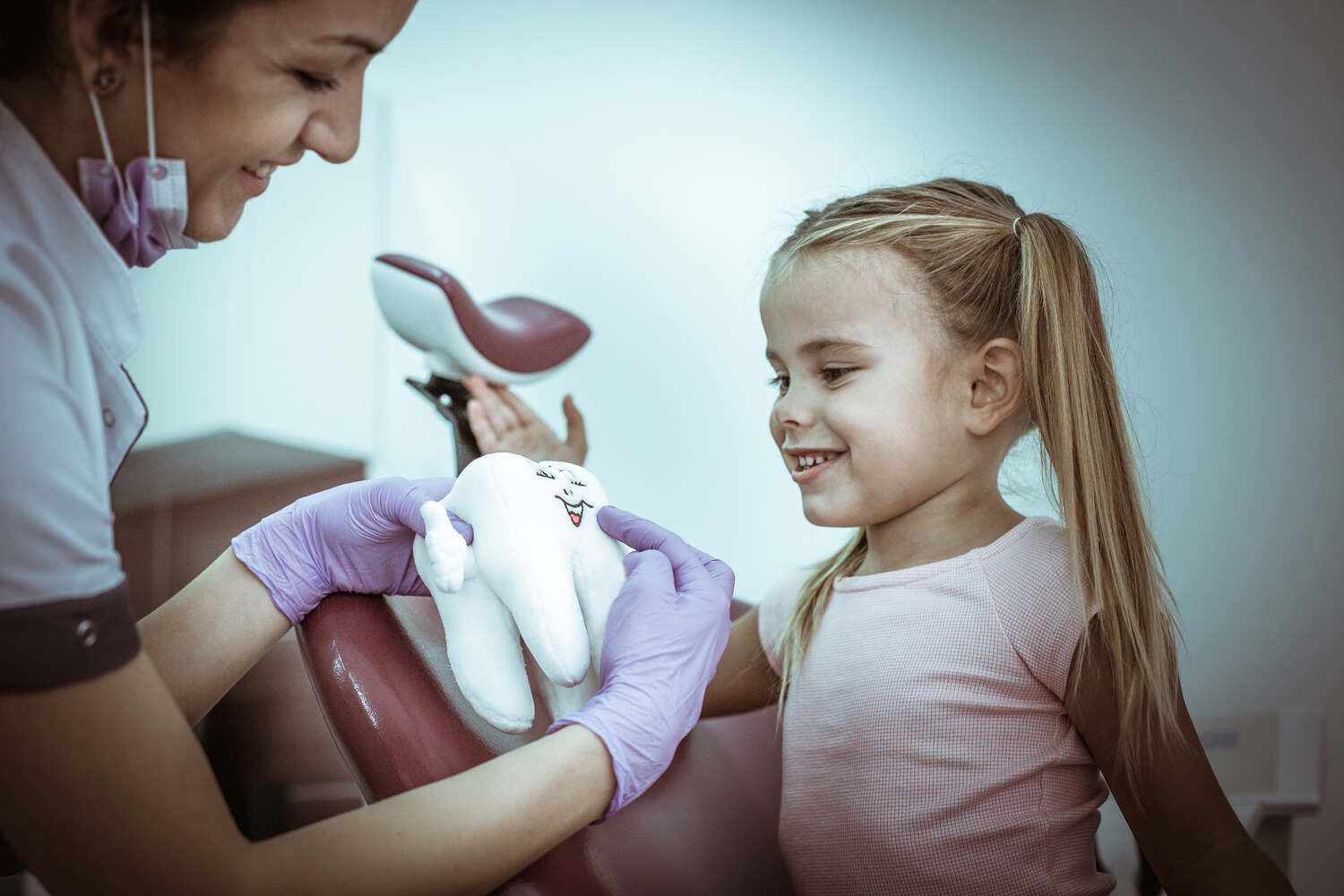 A dentist explaining something to a child