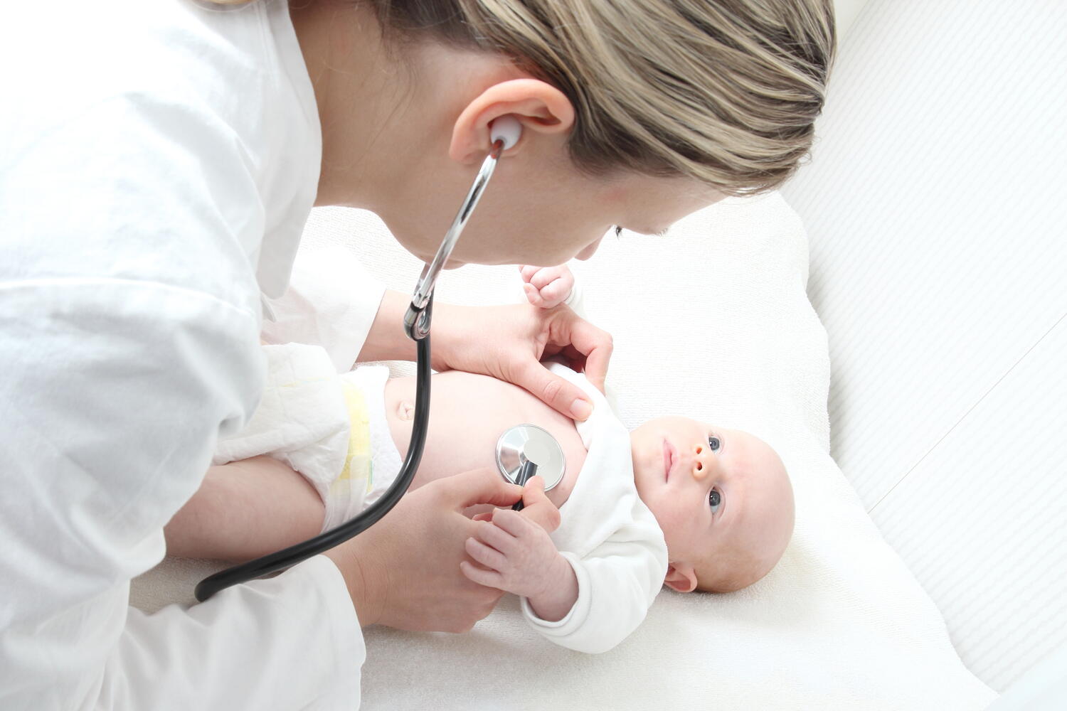 A doctor examining a baby