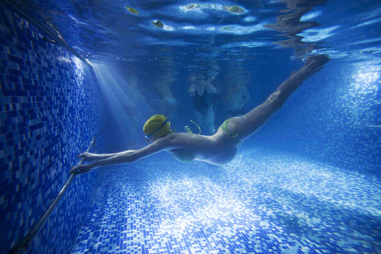 pregnant woman diving in pool