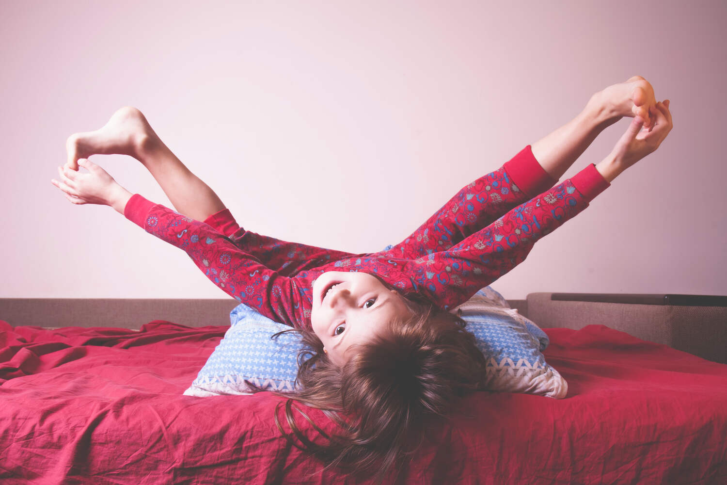 A toddler playing at bed time