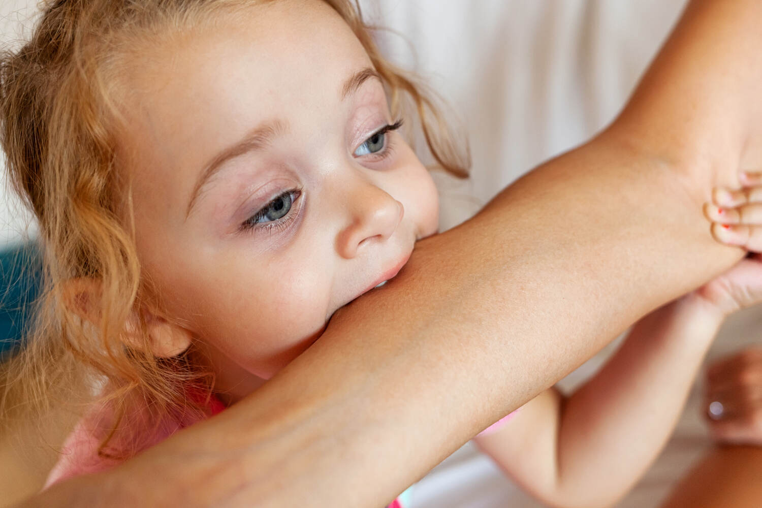 A toddler biting mother