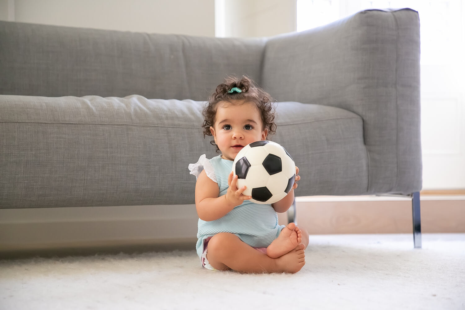 A toddler holding a ball