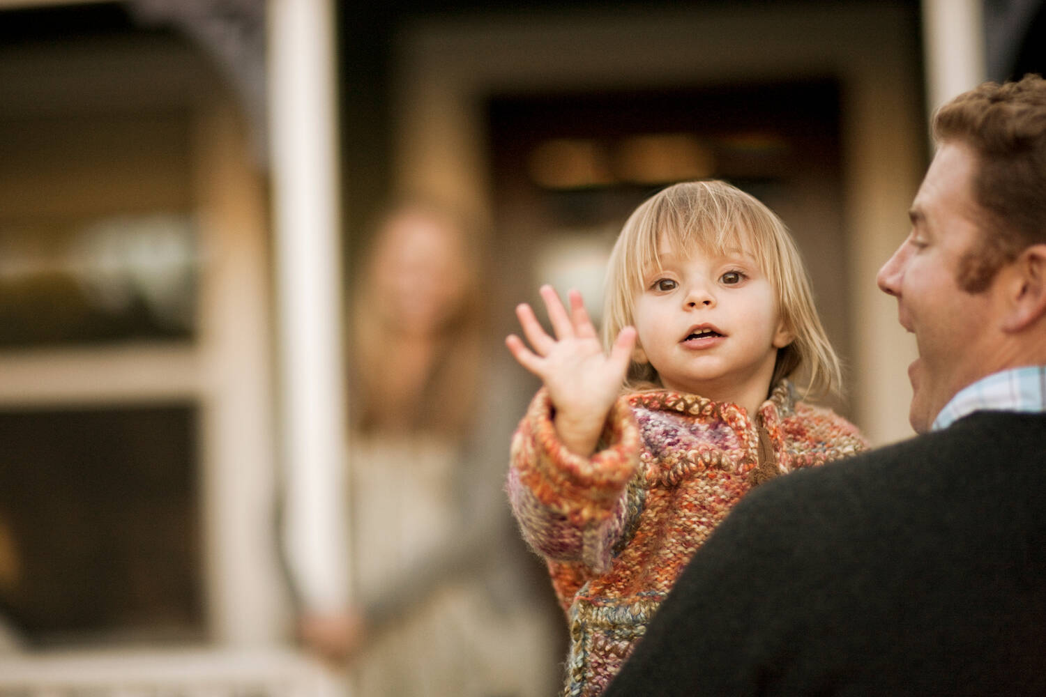 A toddler waving