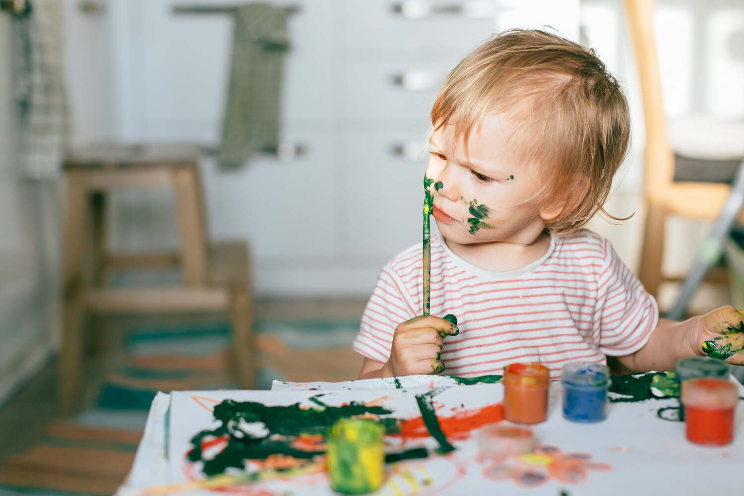 A toddler painting