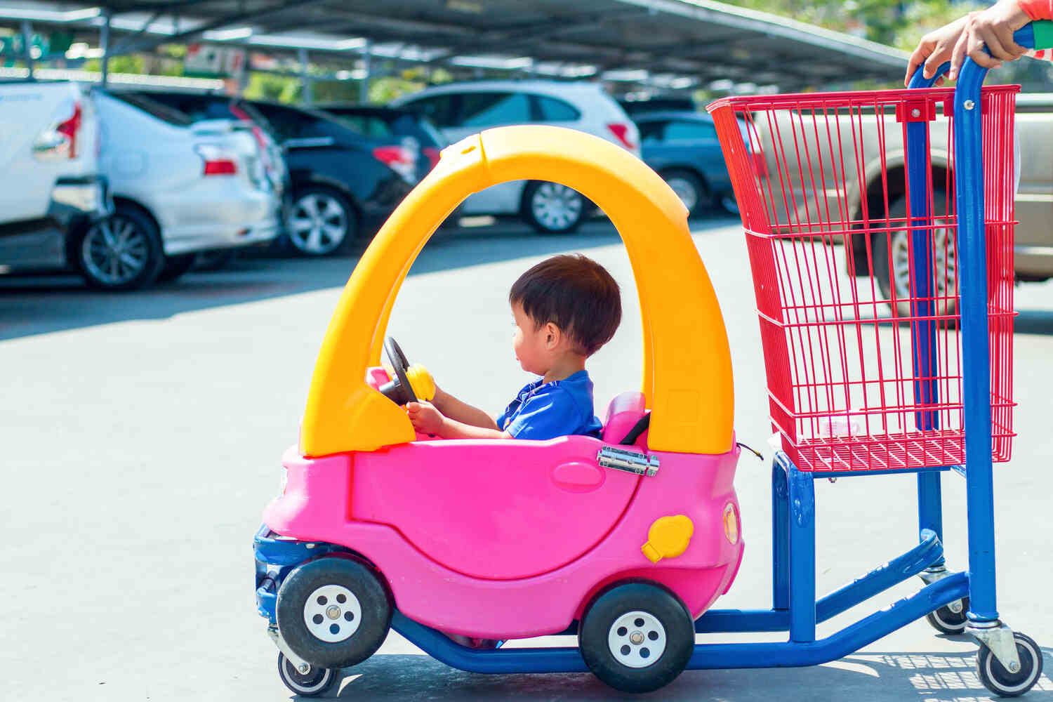 A shopping cart with a car for toddler