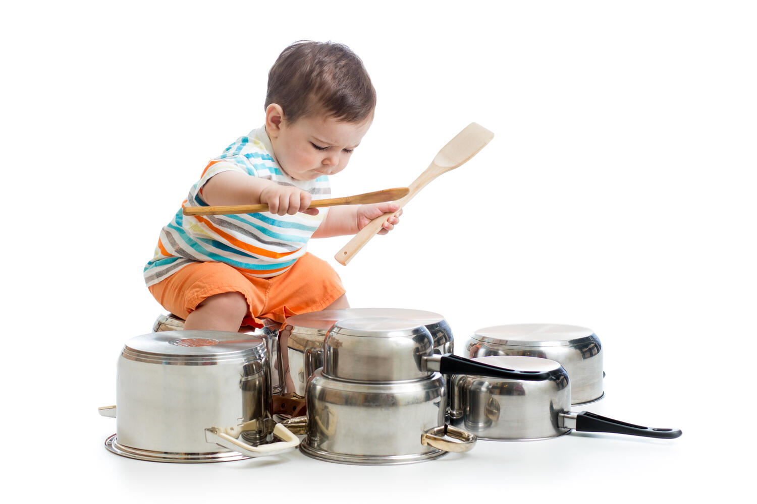 A toddler playing with utensils