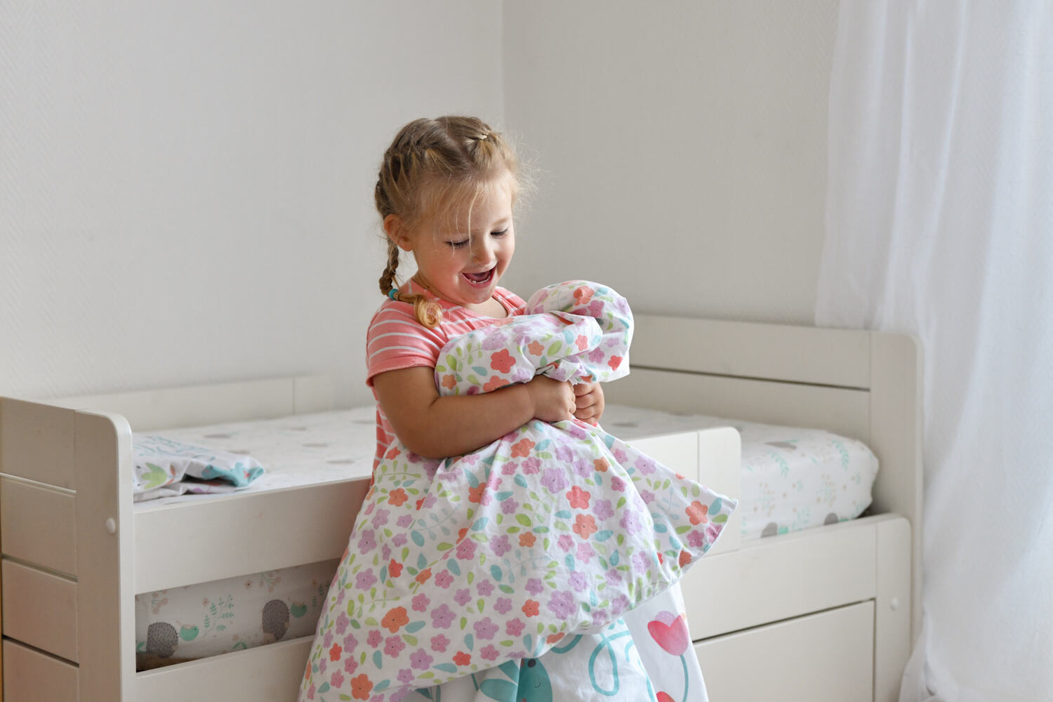 A girl putting a bedsheet