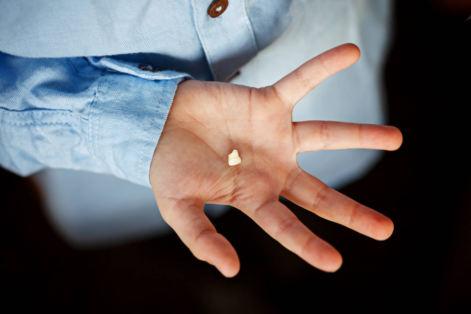 A child holding a tooth