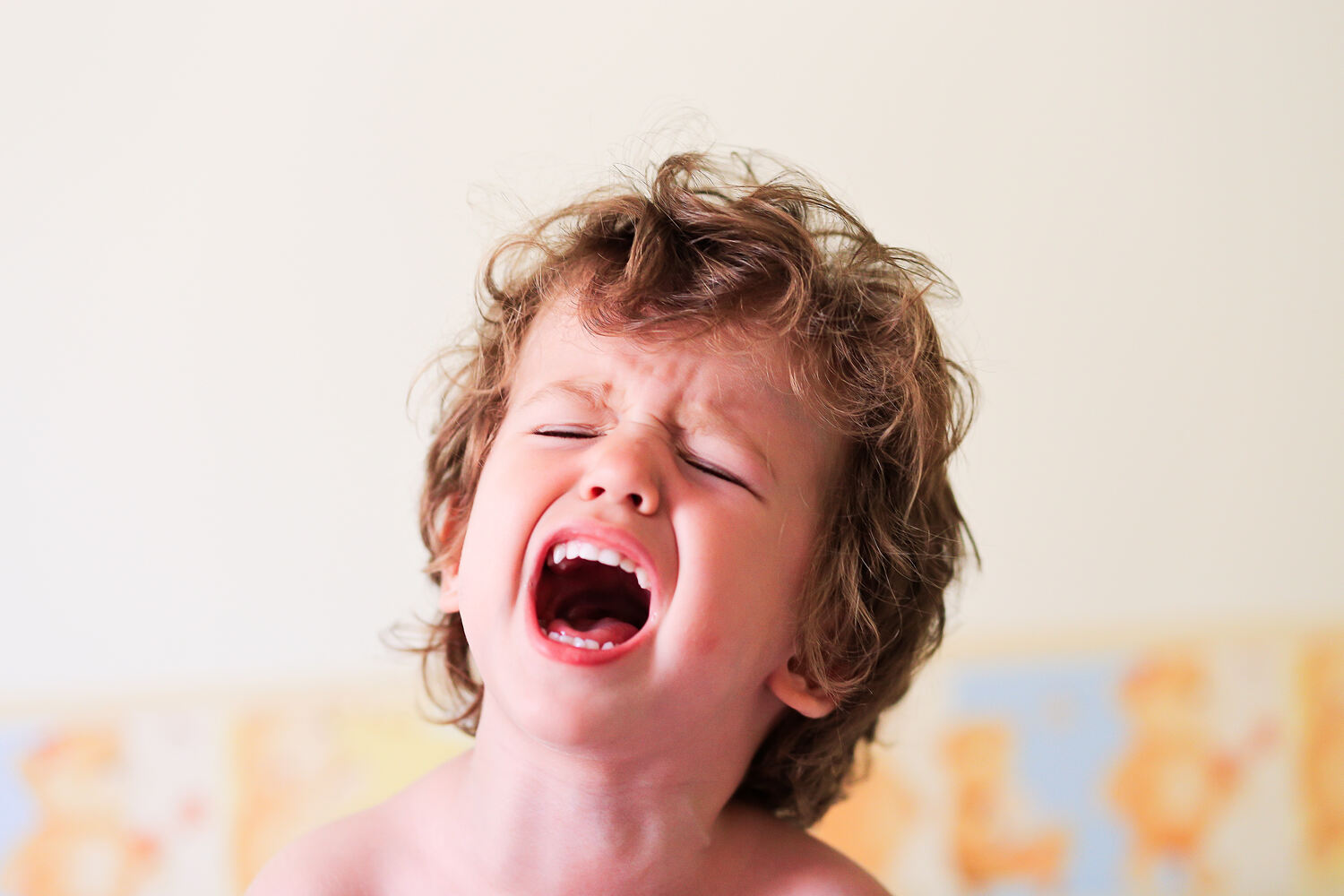 A toddler boy screaming