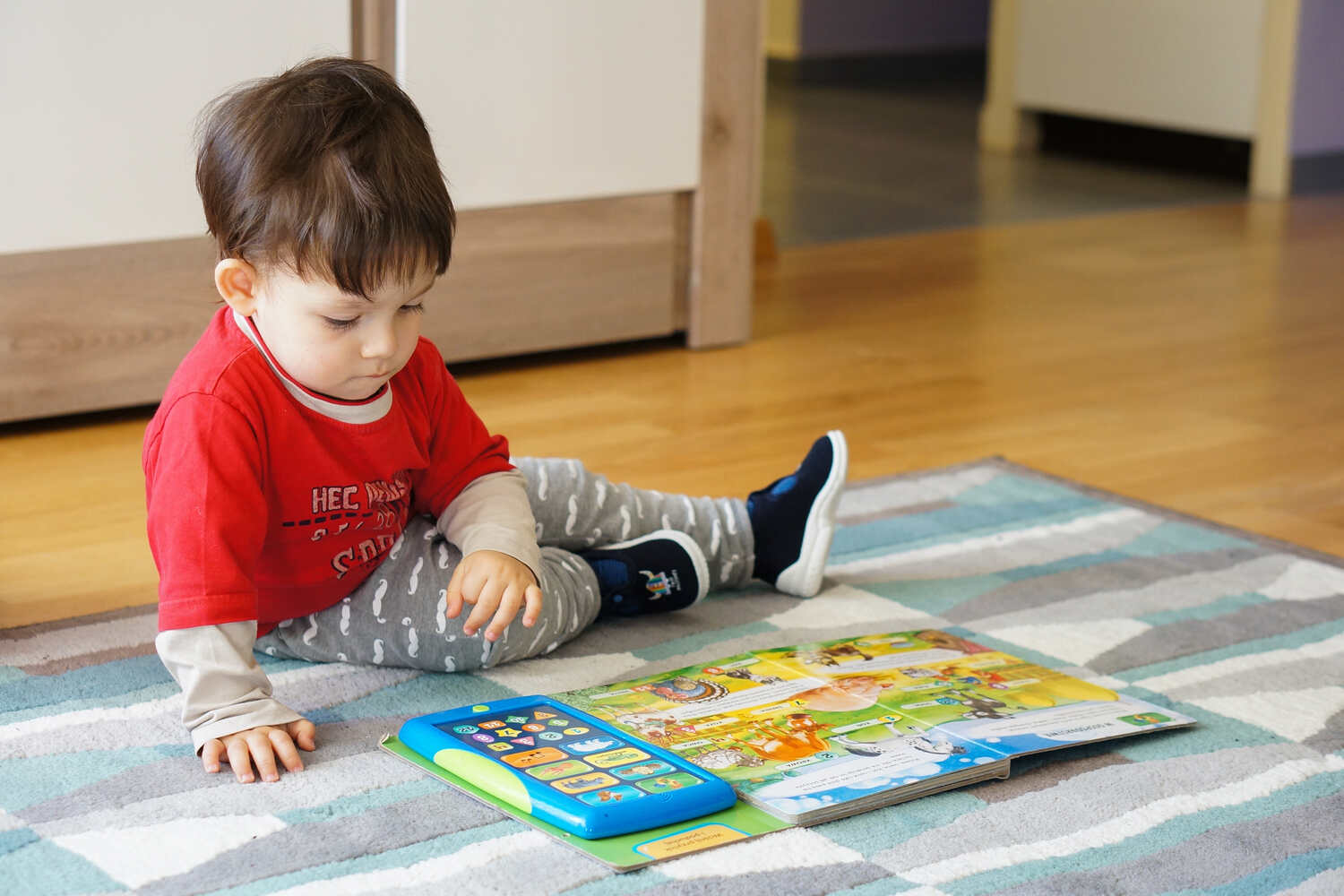 A toddler with his sound book