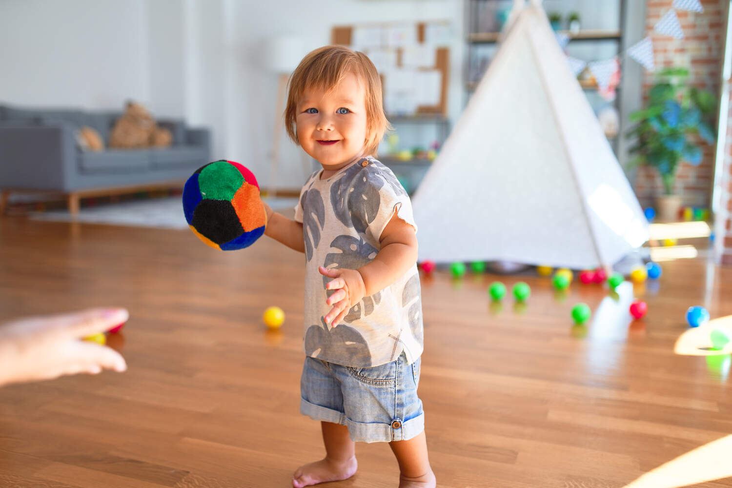 A toddler throwing ball