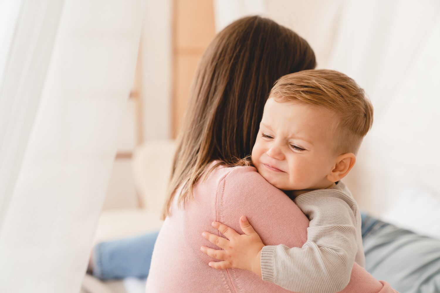 A mother soothing her toddler 